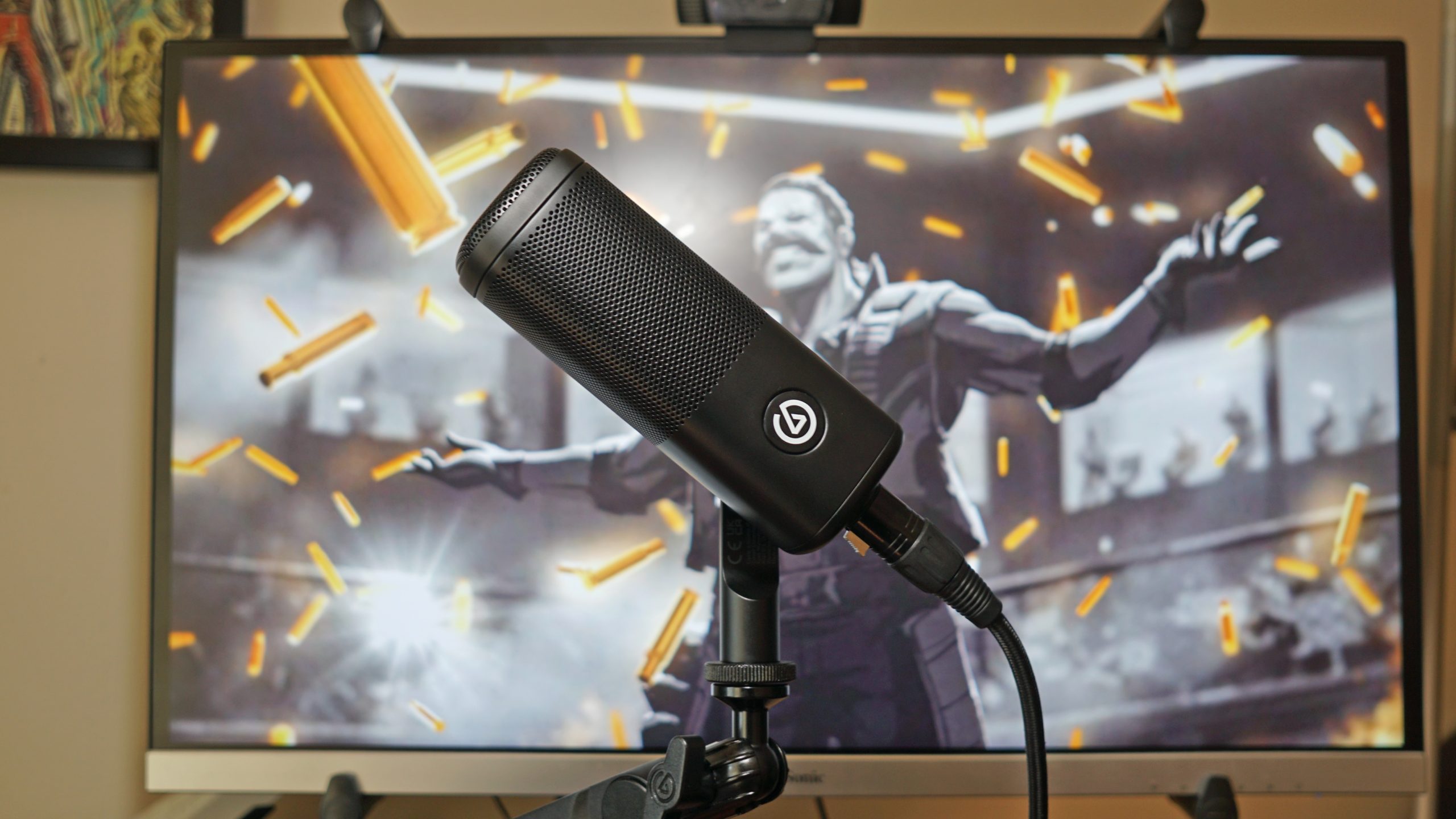 The Elgato Wave DX sits on a microphone arm in front of a Viewsonic monitor displaying Apex Legends.
