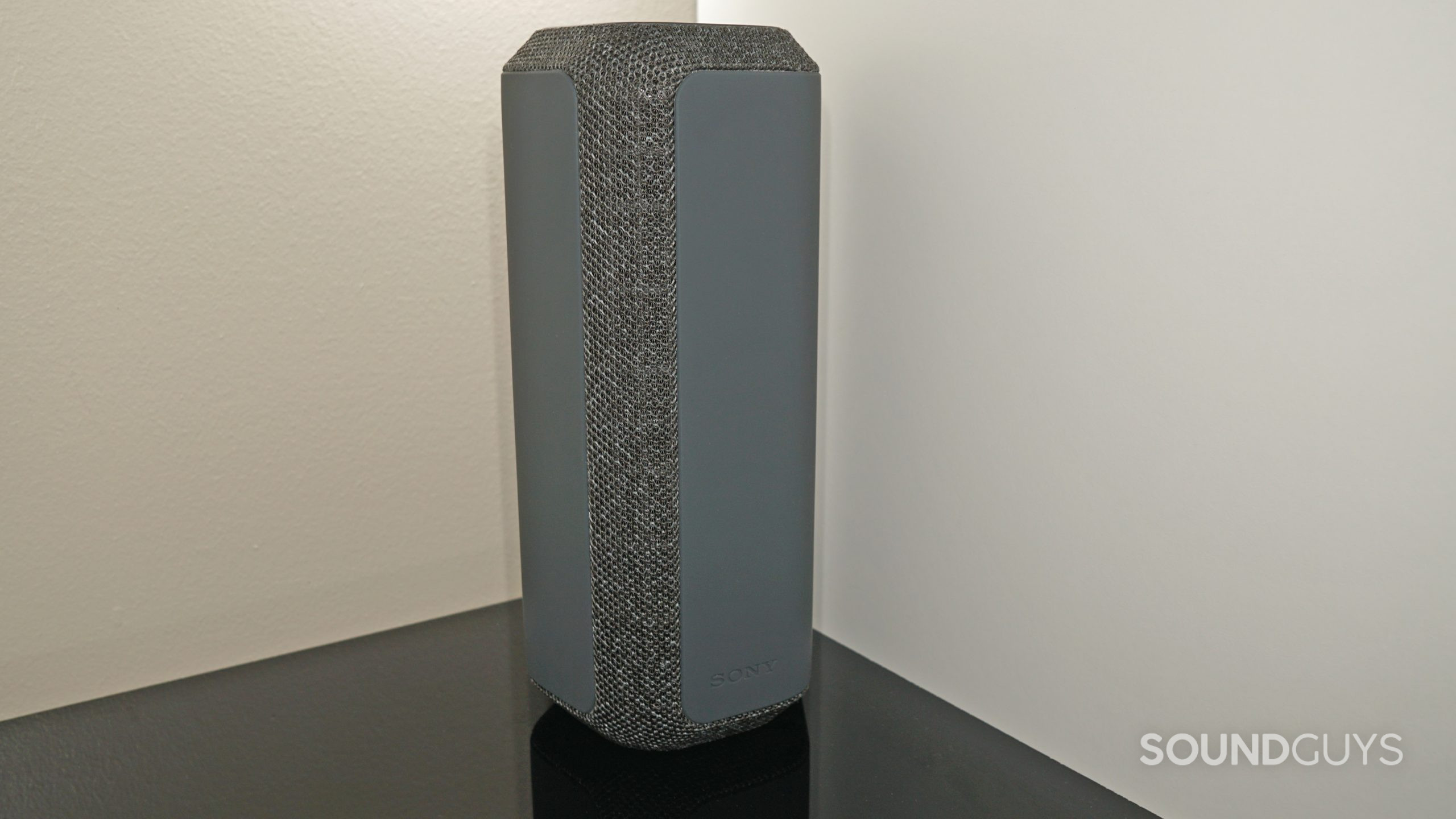 The Sony SRS-XE300 bluetooth speaker stands on a shelf.