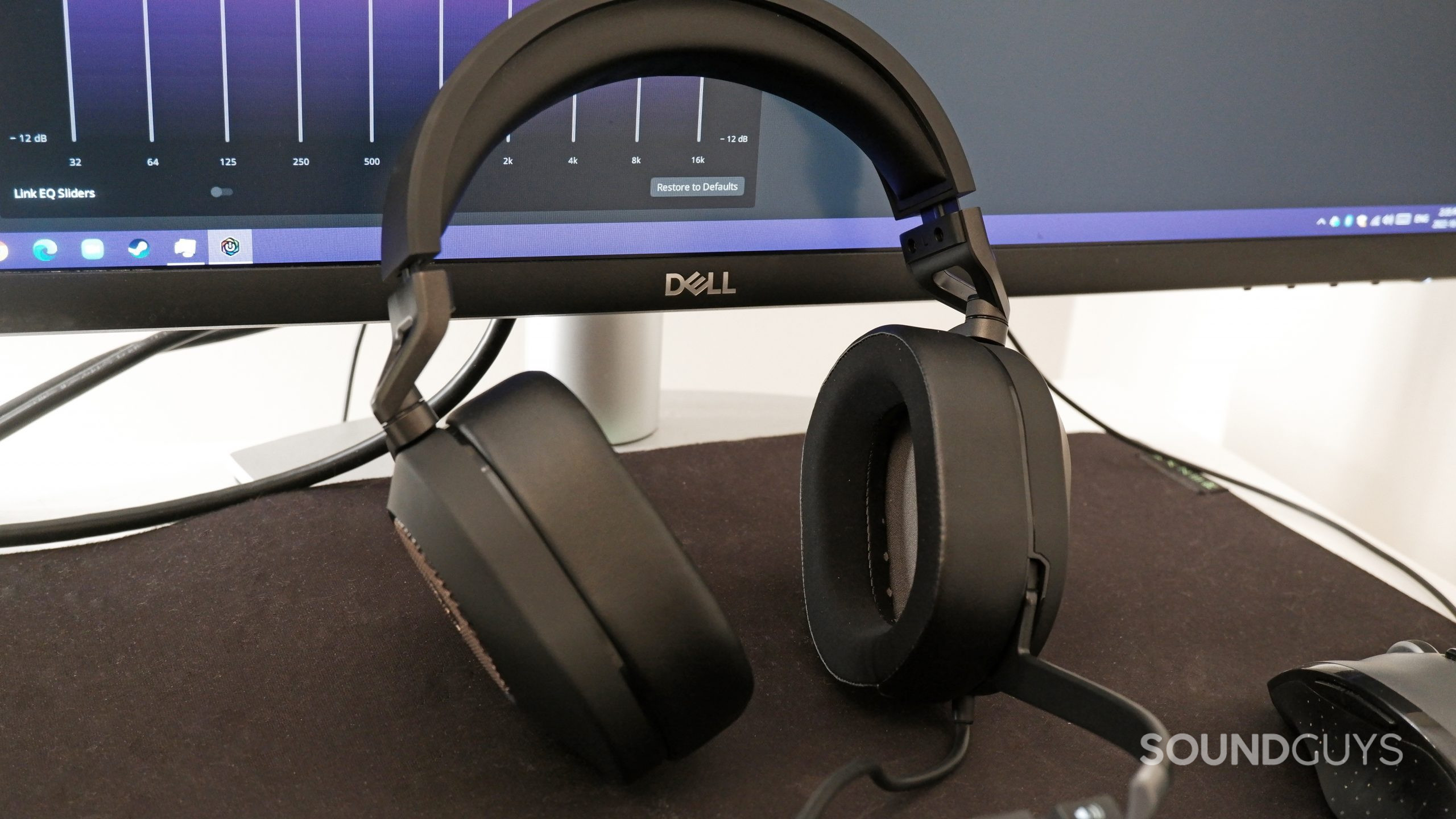 The Corsair HS65 Surround resting against a computer monitor with the iCue software running.