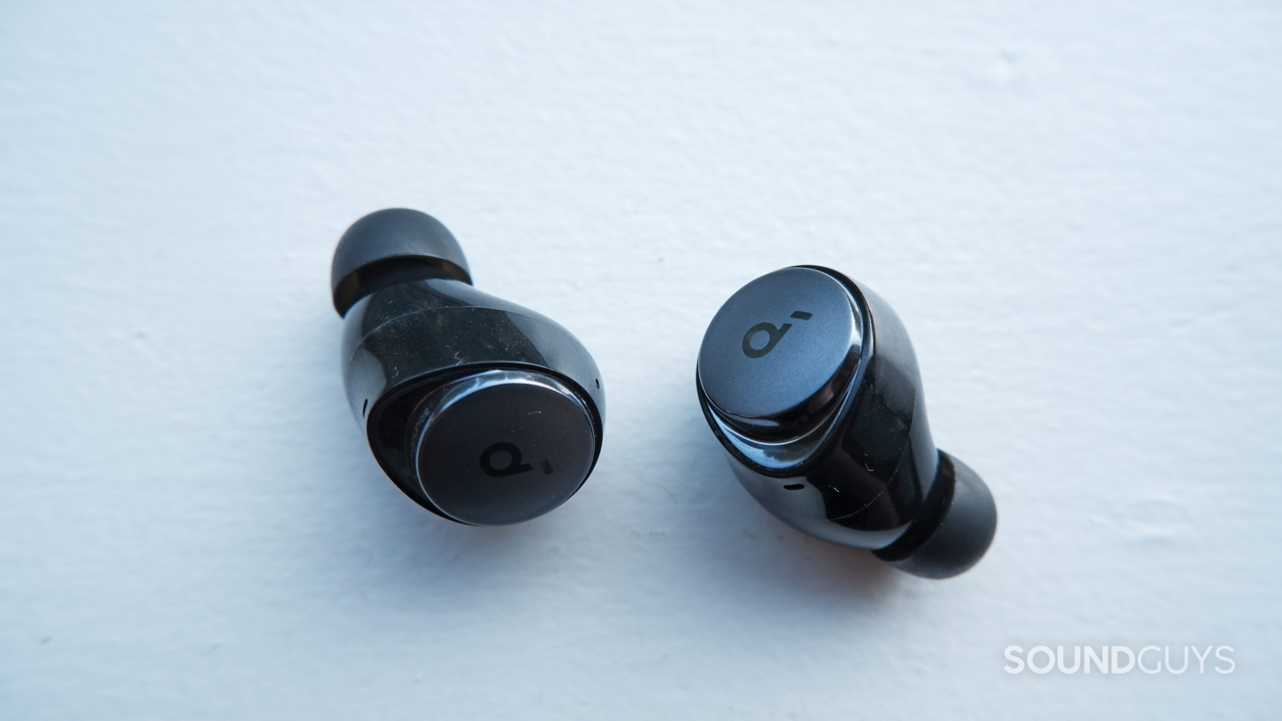 The Anker Soundcore Space A40 earbuds up close on a white surface.