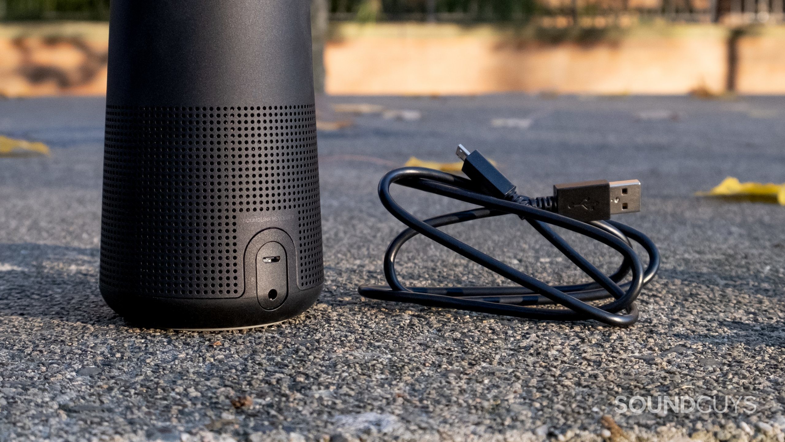 A close up of the Bose SoundLink Revolve II showing the aux in and charging port with the microUSB cable.