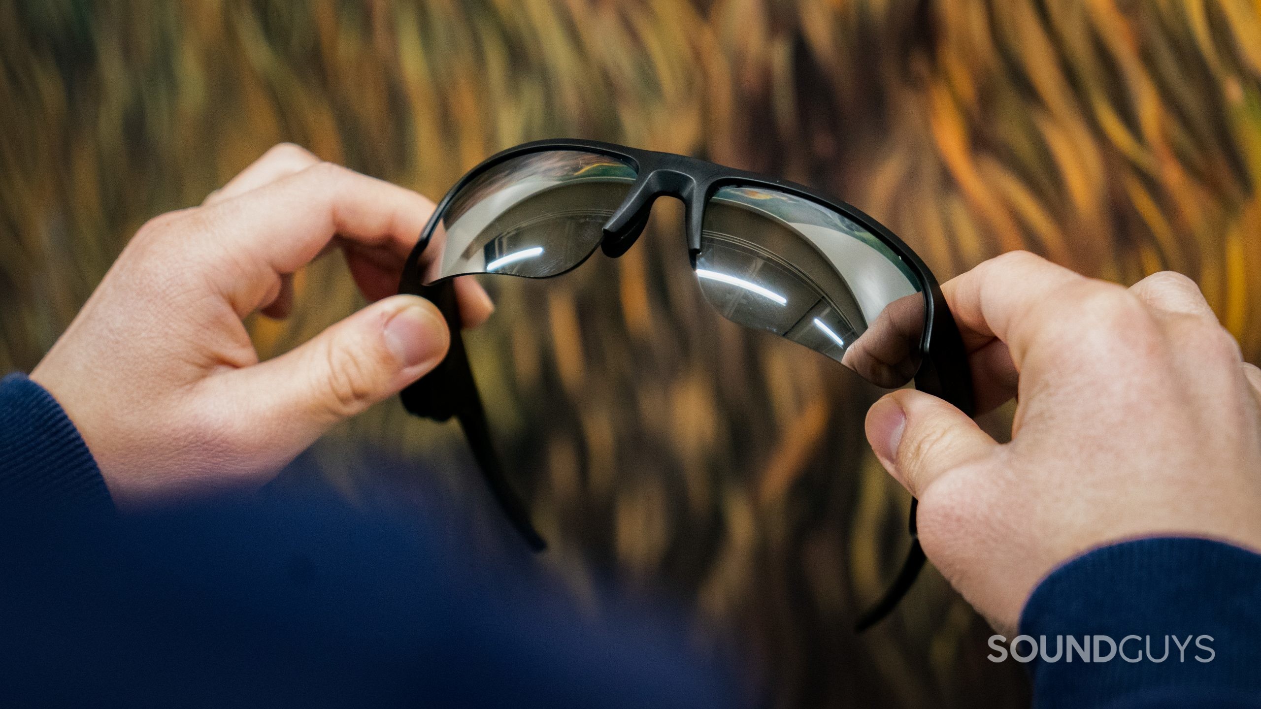 Bose Frames Tempo Model Image #2 Bose Frames Tempo held by two hands showing lens detail.