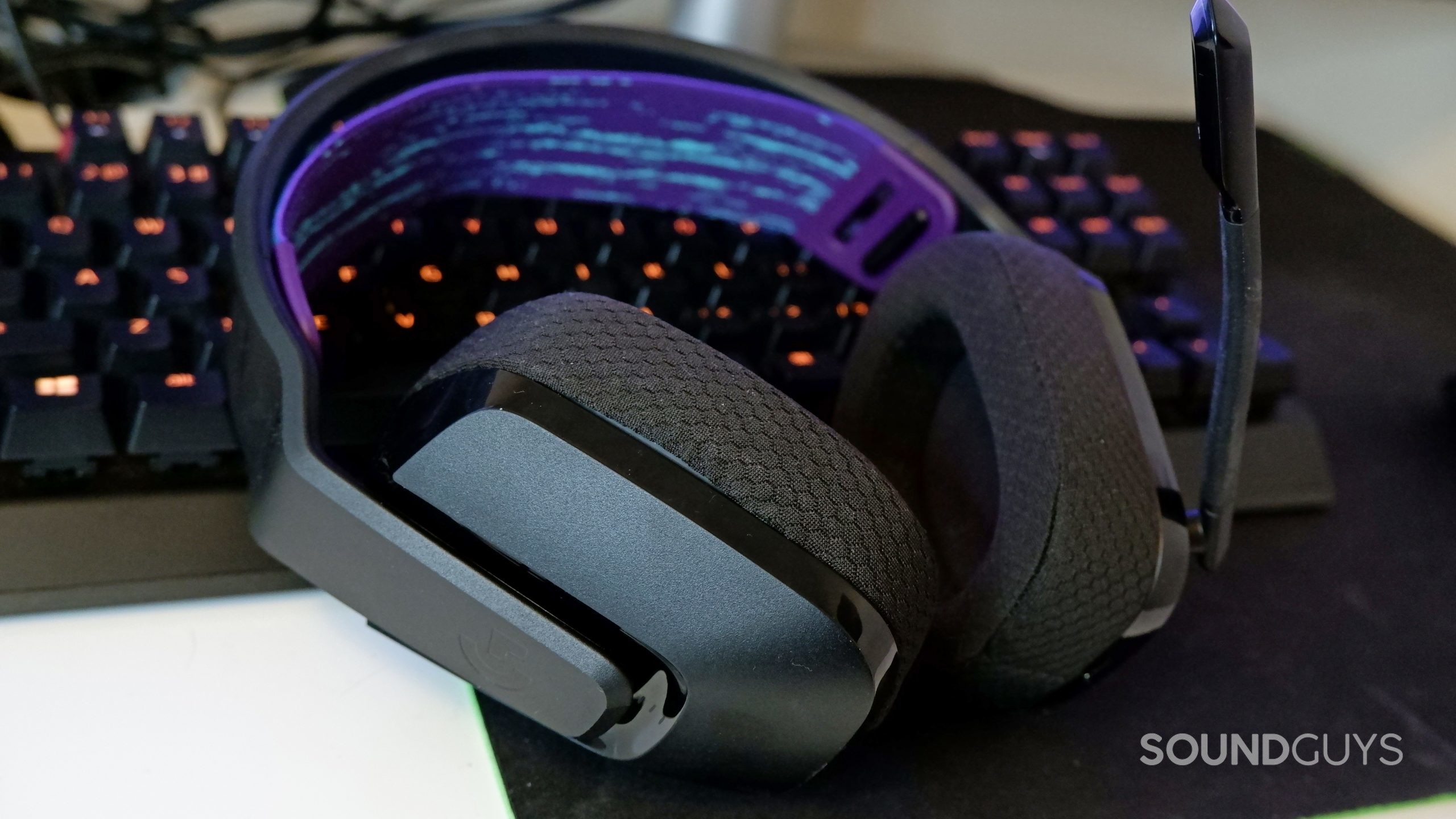 The Logitech G535 resting against a keyboard on a desk.