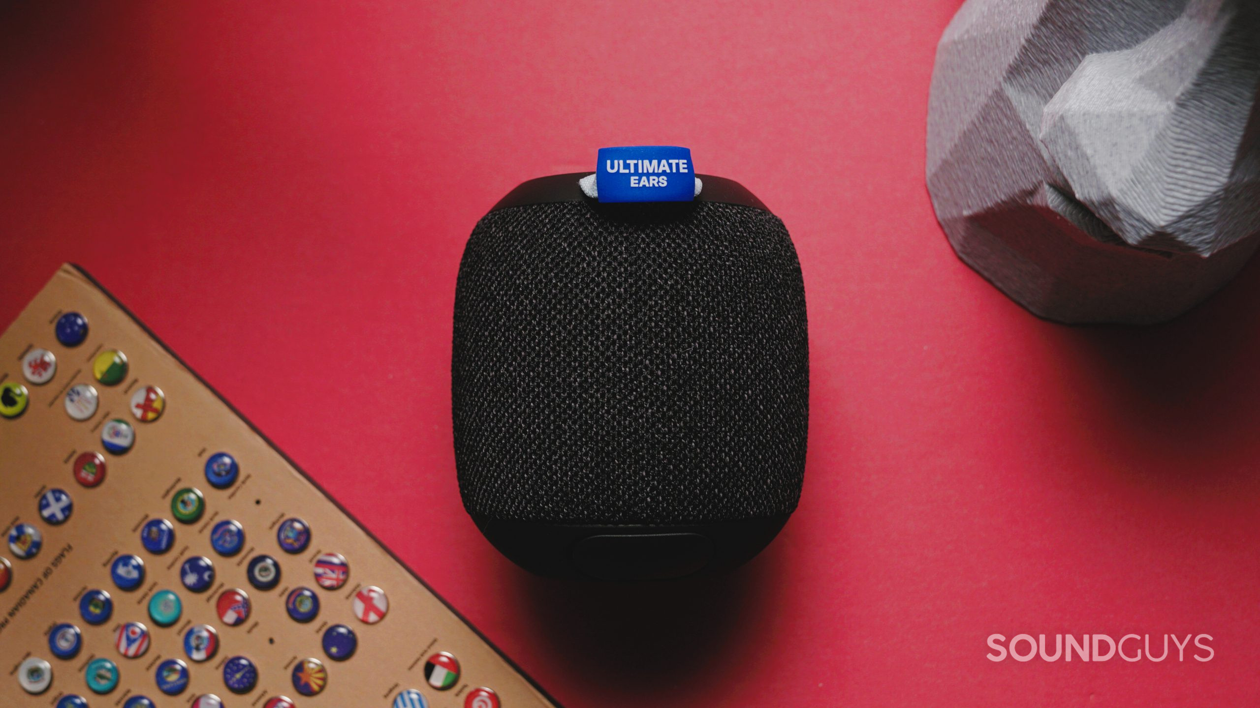 The Ultimate Ears Wonderboom 3 sitting on a red desk next to some baubles.