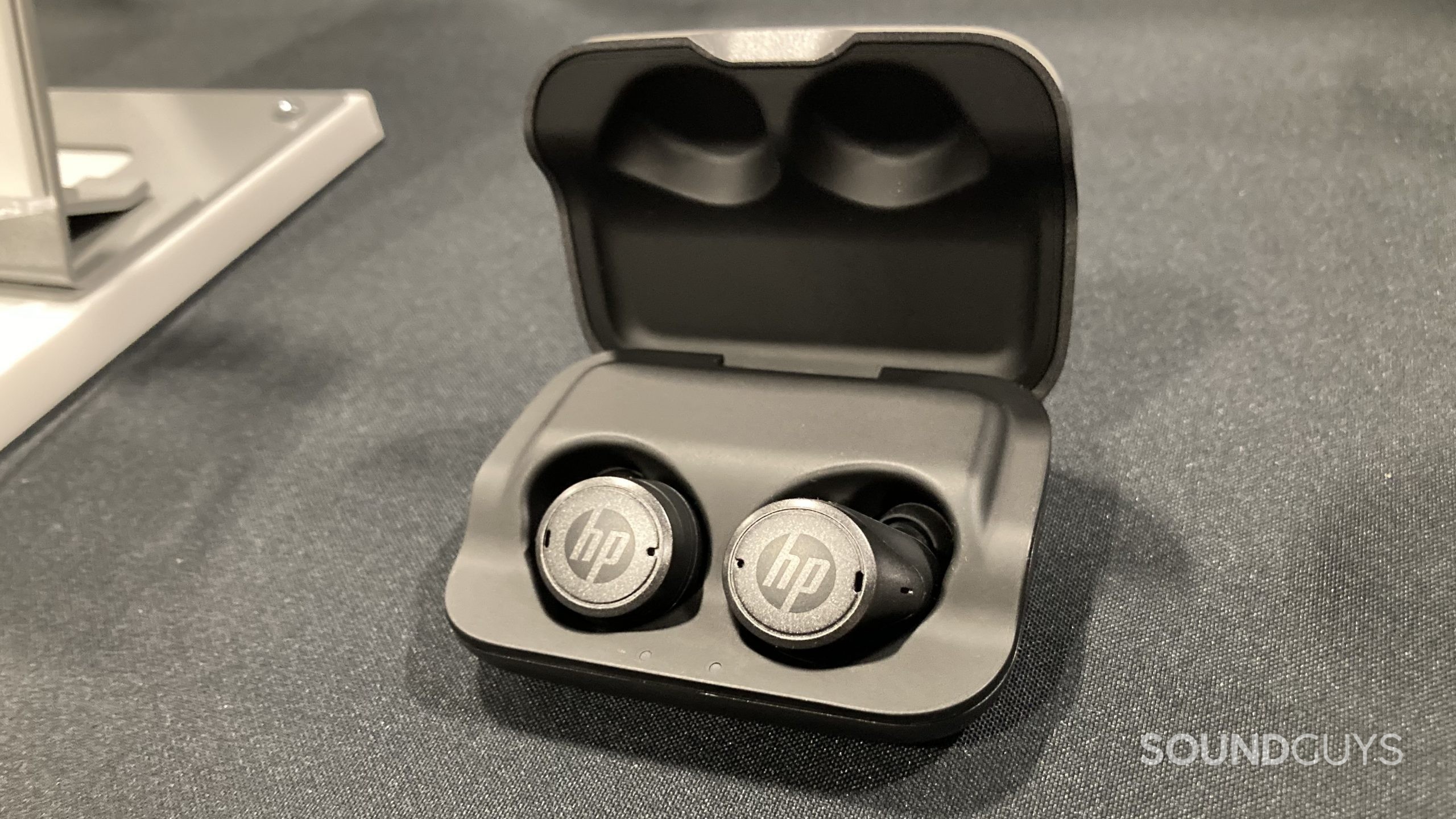 HP Hearing PRO earbuds in charging case.