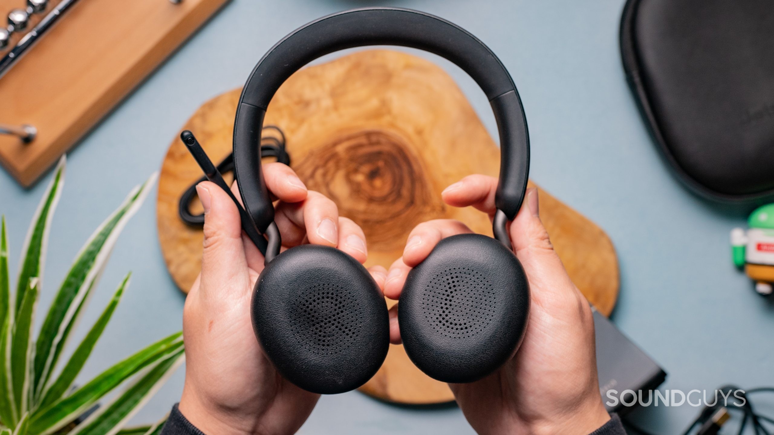 The Jabra Evolve2 65 being held in someone's hands with the earcups facing towards the viewer.