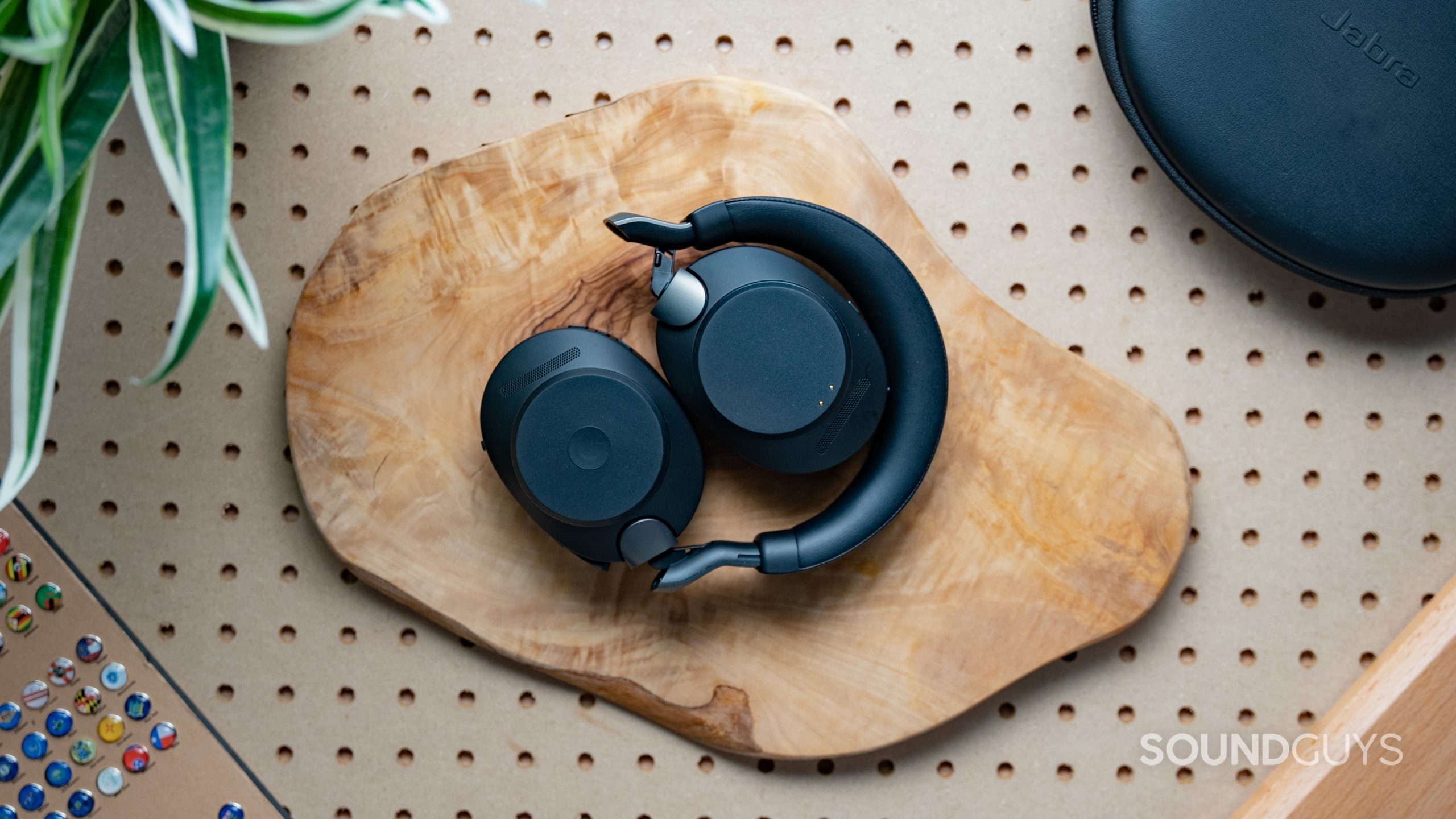 Jabra Evolve2 85 folded up on a wooden surface.