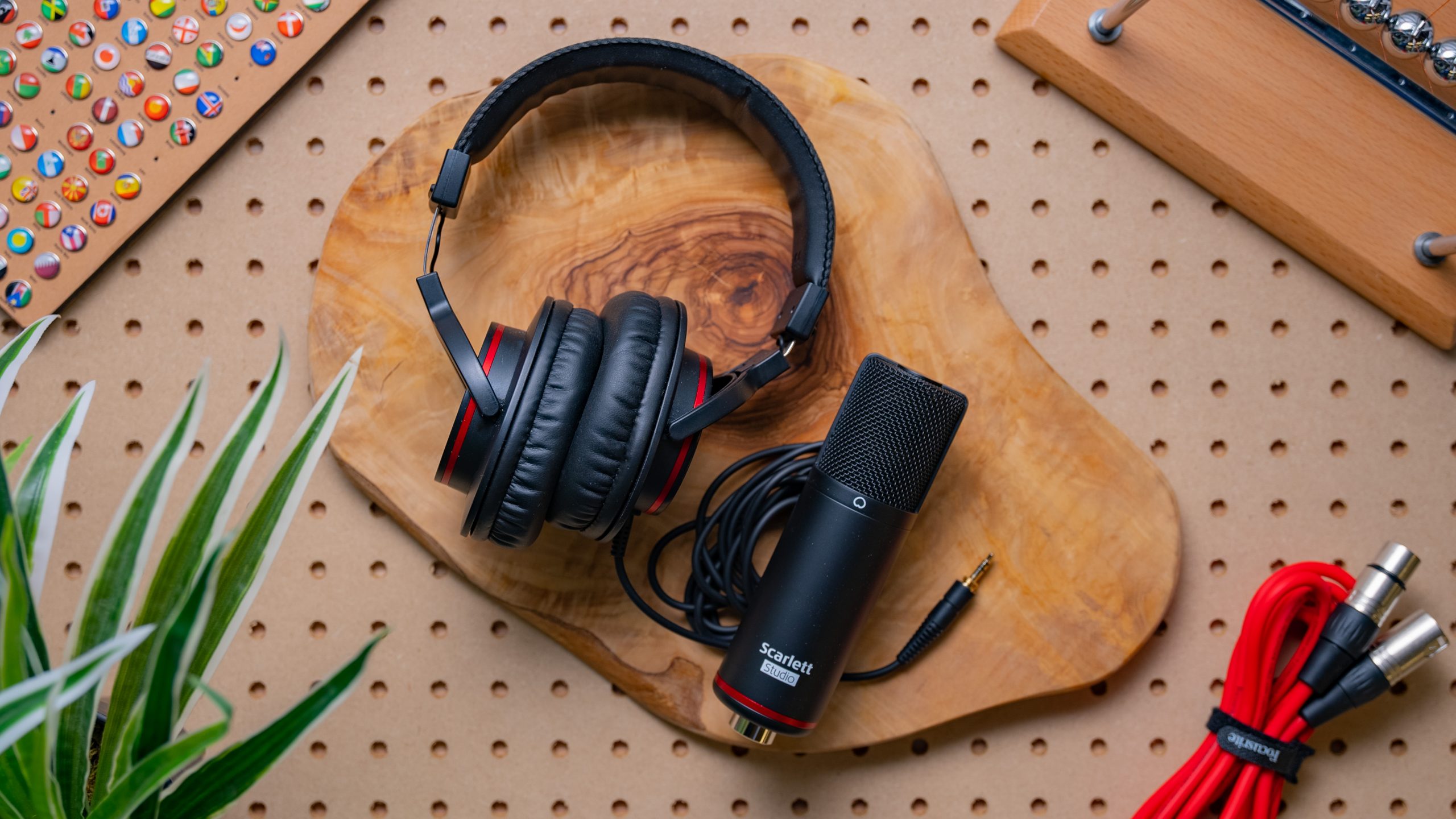 The Focusrite Scarlett HP60 MkIII headphones and Focusrite CM35 MkIII lay on a wooden surface, with their cables nearby.