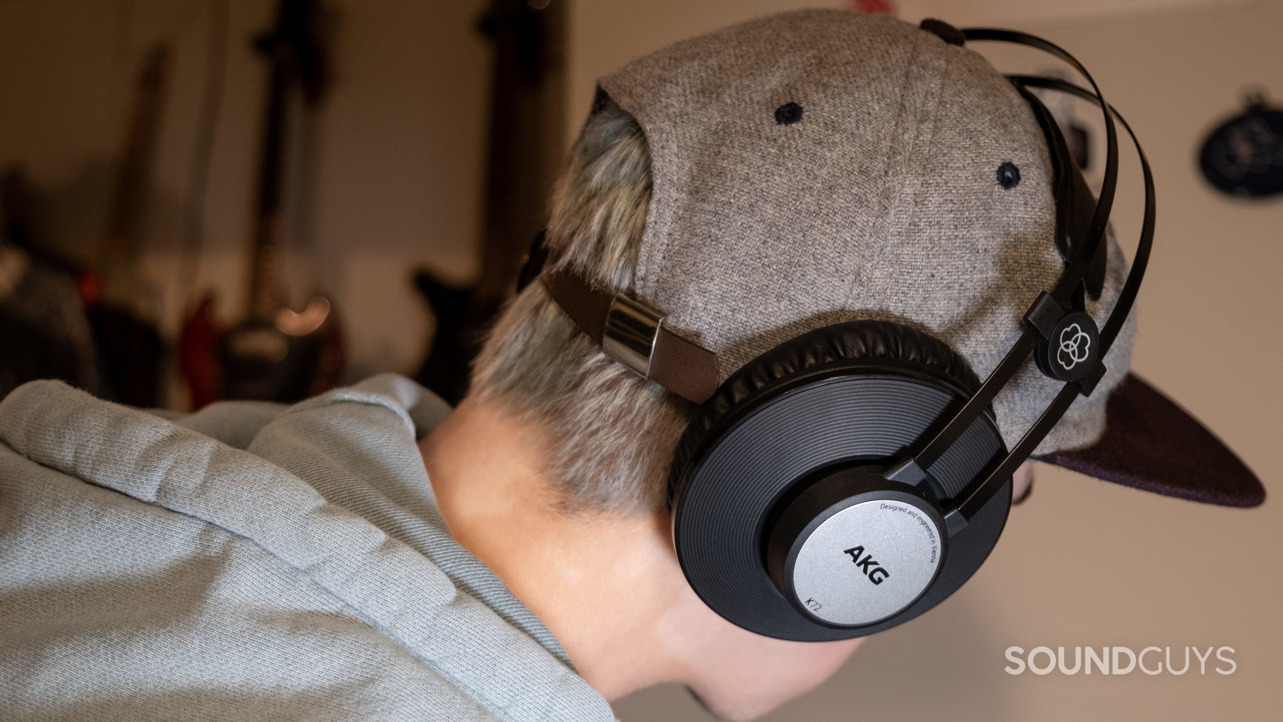 The AKG K72 as worn on a person facing away from the camera wearing a hat.