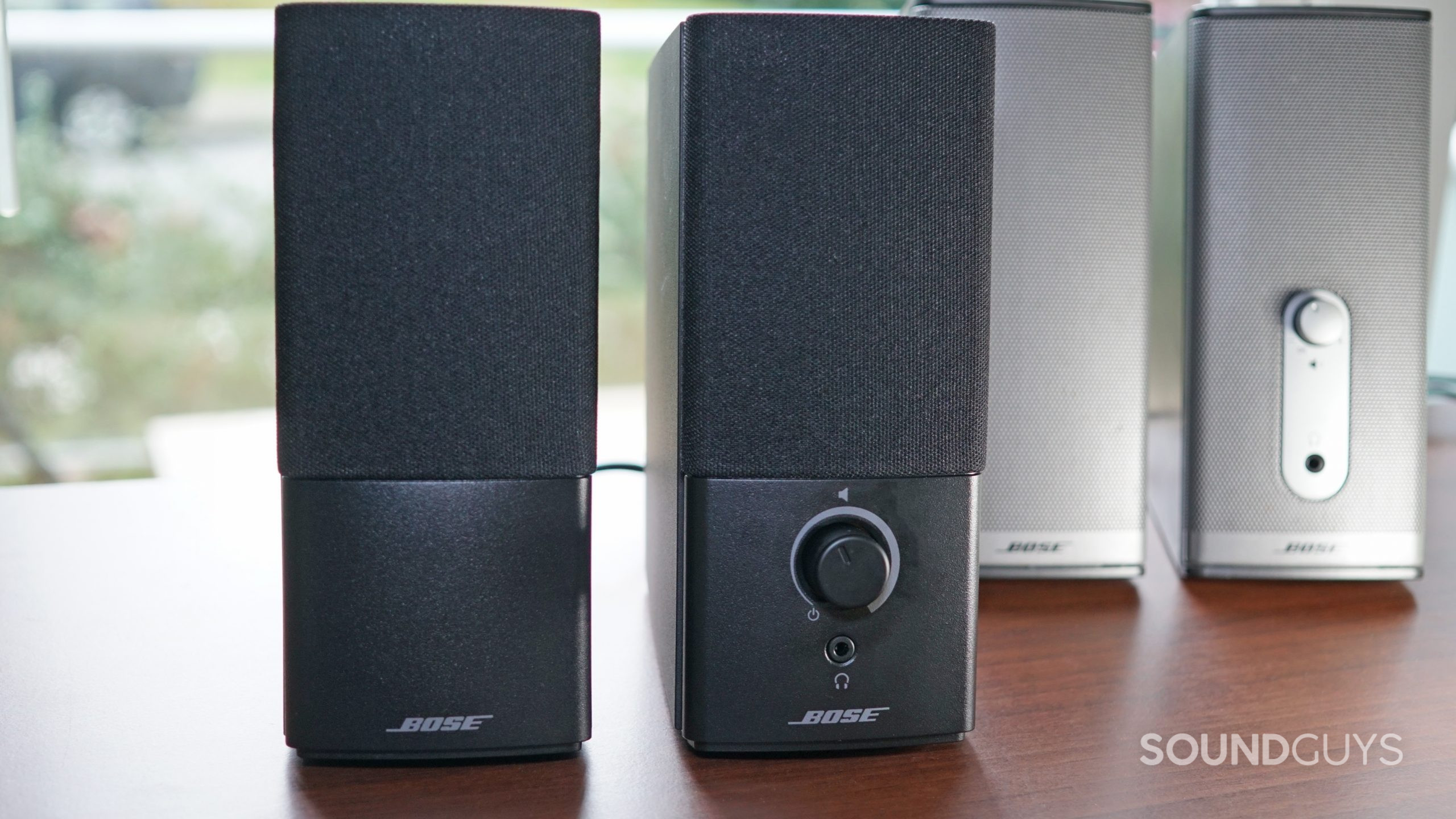 The Bose Companion 2 Series III sits next to the Bose Companion 2 Series II speakers on a wooden surface.