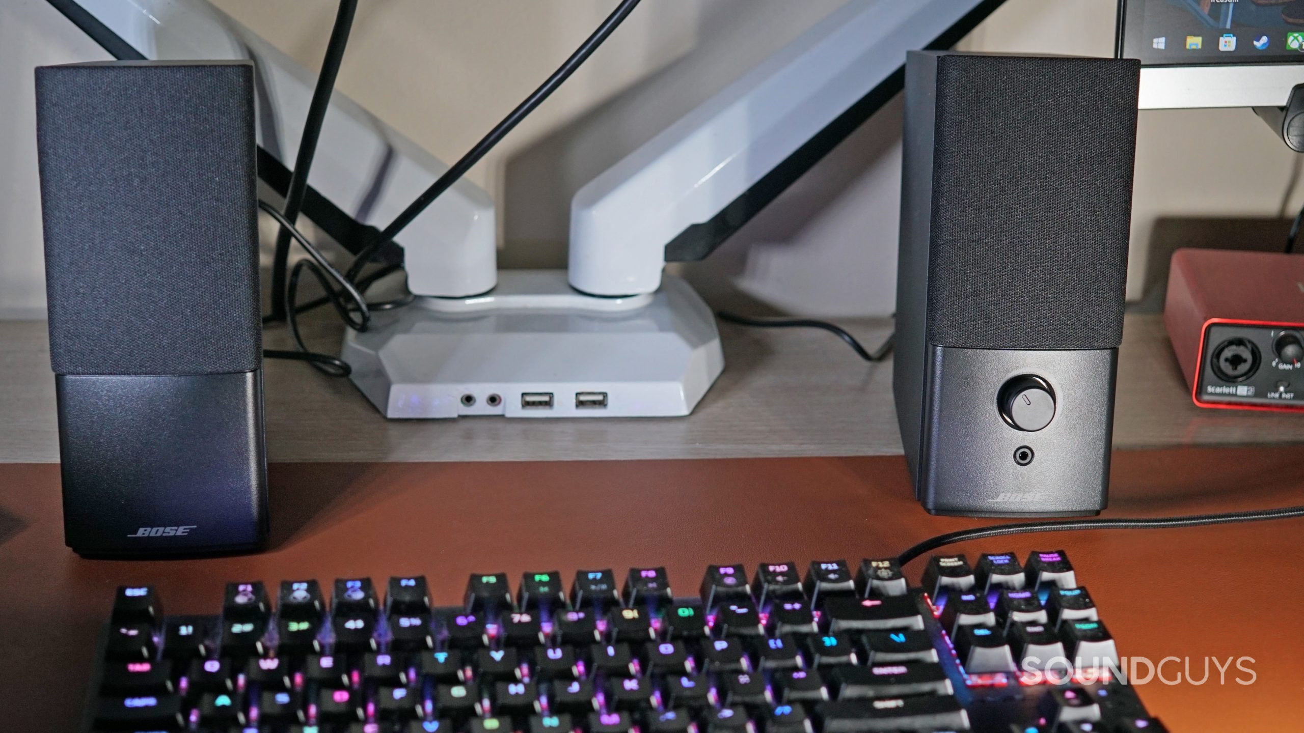 The Bose Companion 2 Series III speakers sit on a computer desk next to a HyperX mechanical keyboard and a focusrite scarlett 2i2.