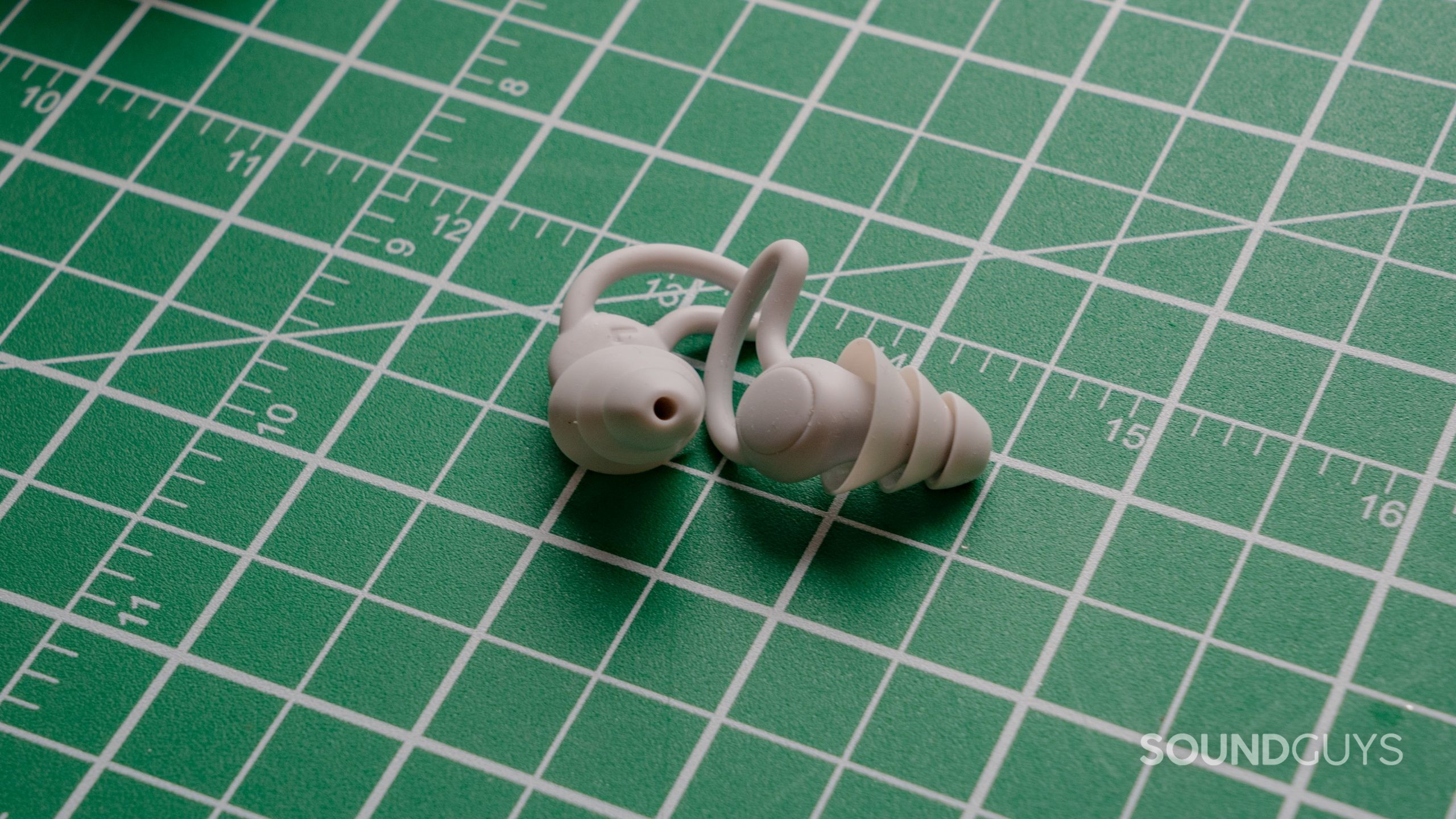 Groundshaker earplugs against a white on green grid.