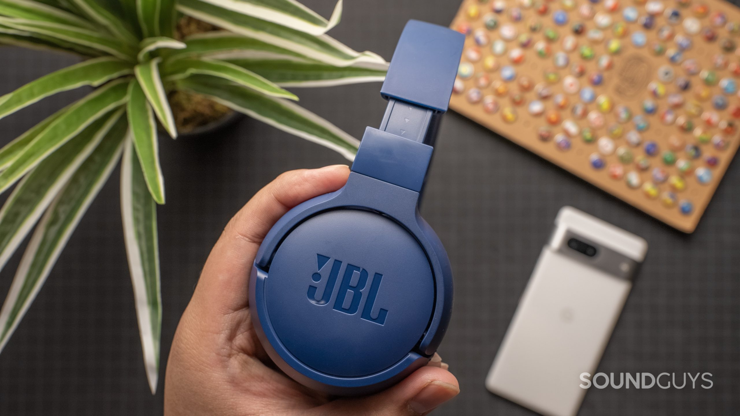 JBL Tune 660NC headphones in hand
