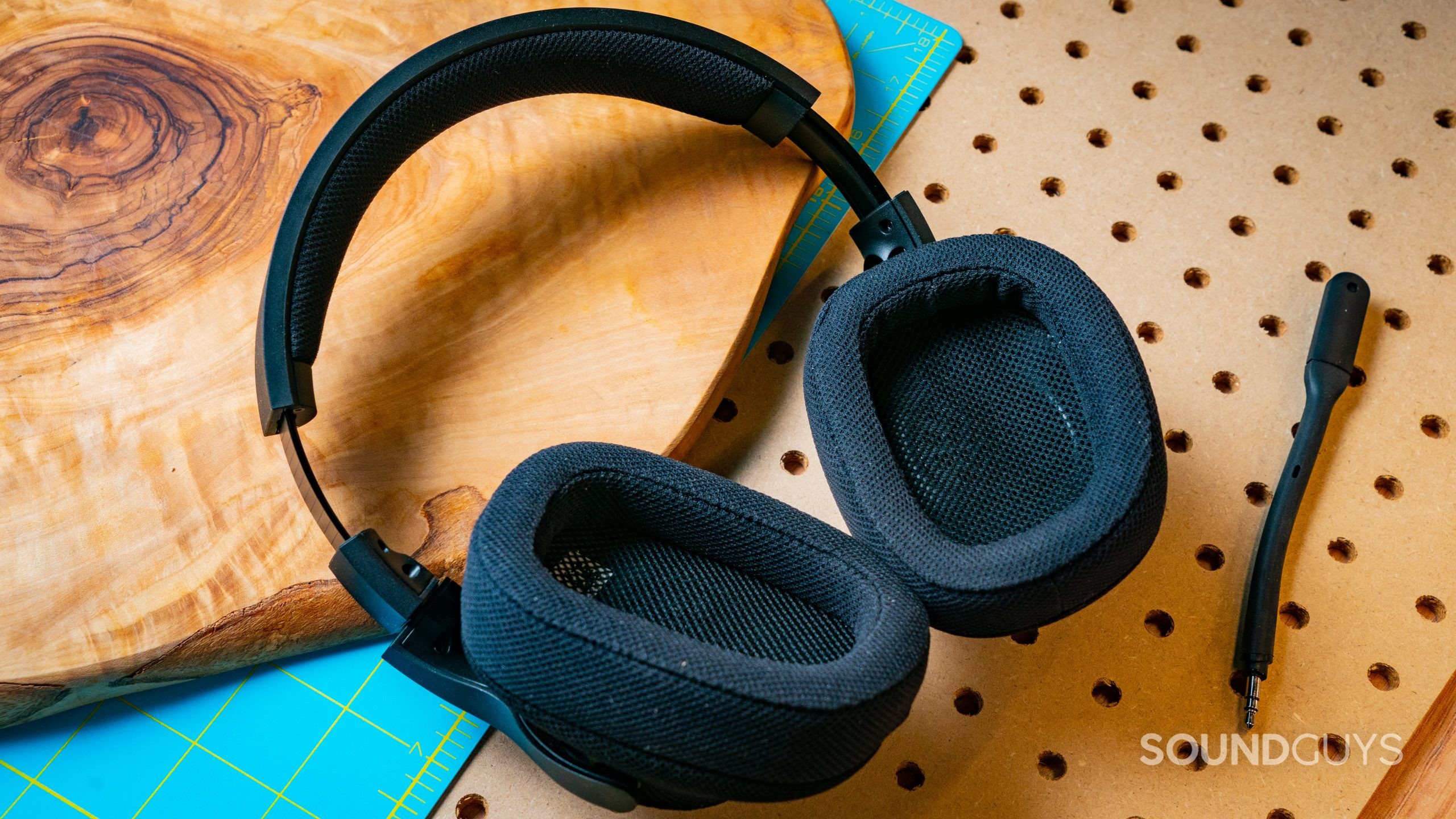 The Logitech G433 sitting on top of a wooden surface with the insides of the ear cups facing the viewer.