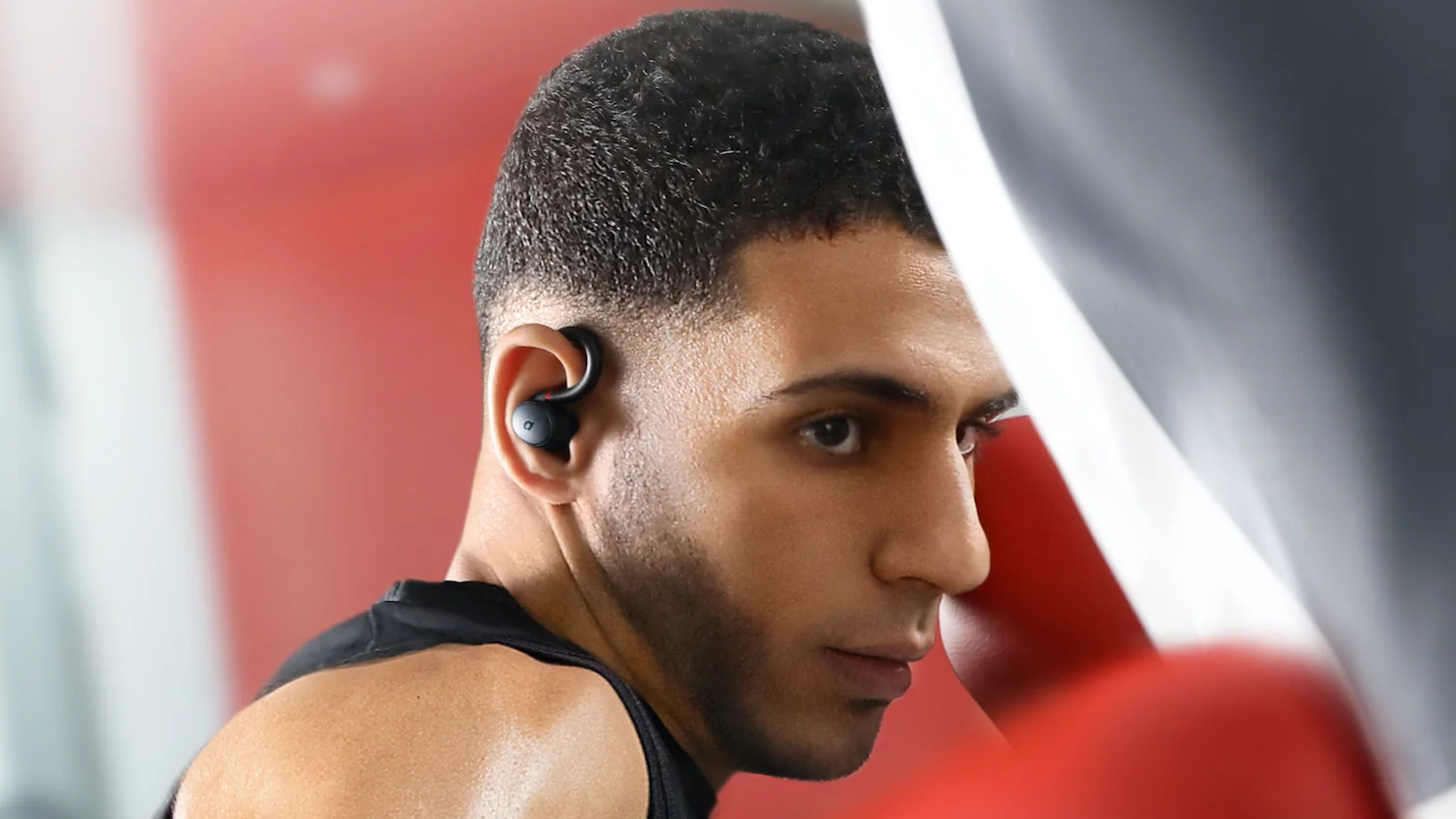 A man wearing Anker Soundcore Sport X10 wireless earbuds