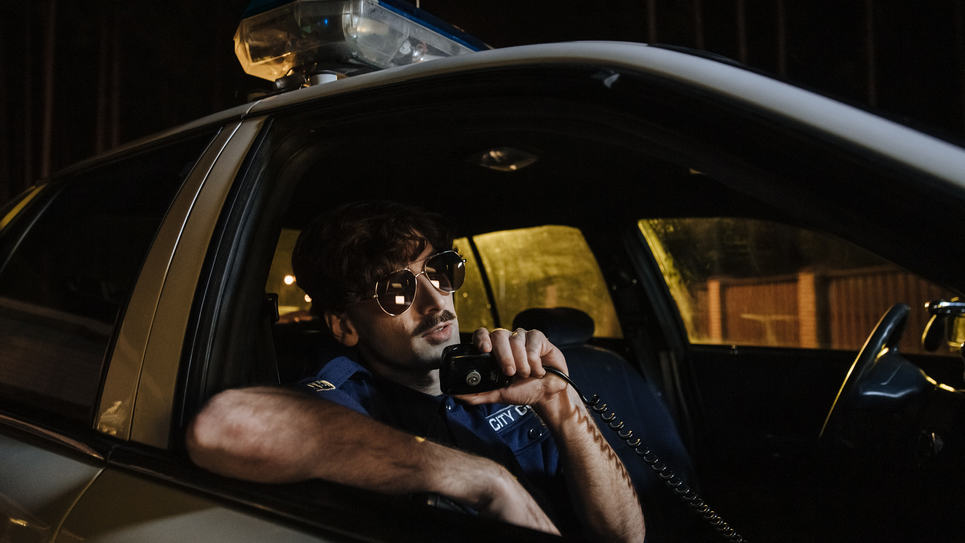 A photo of a police officer calling into dispatch on their cruiser's CB radio.