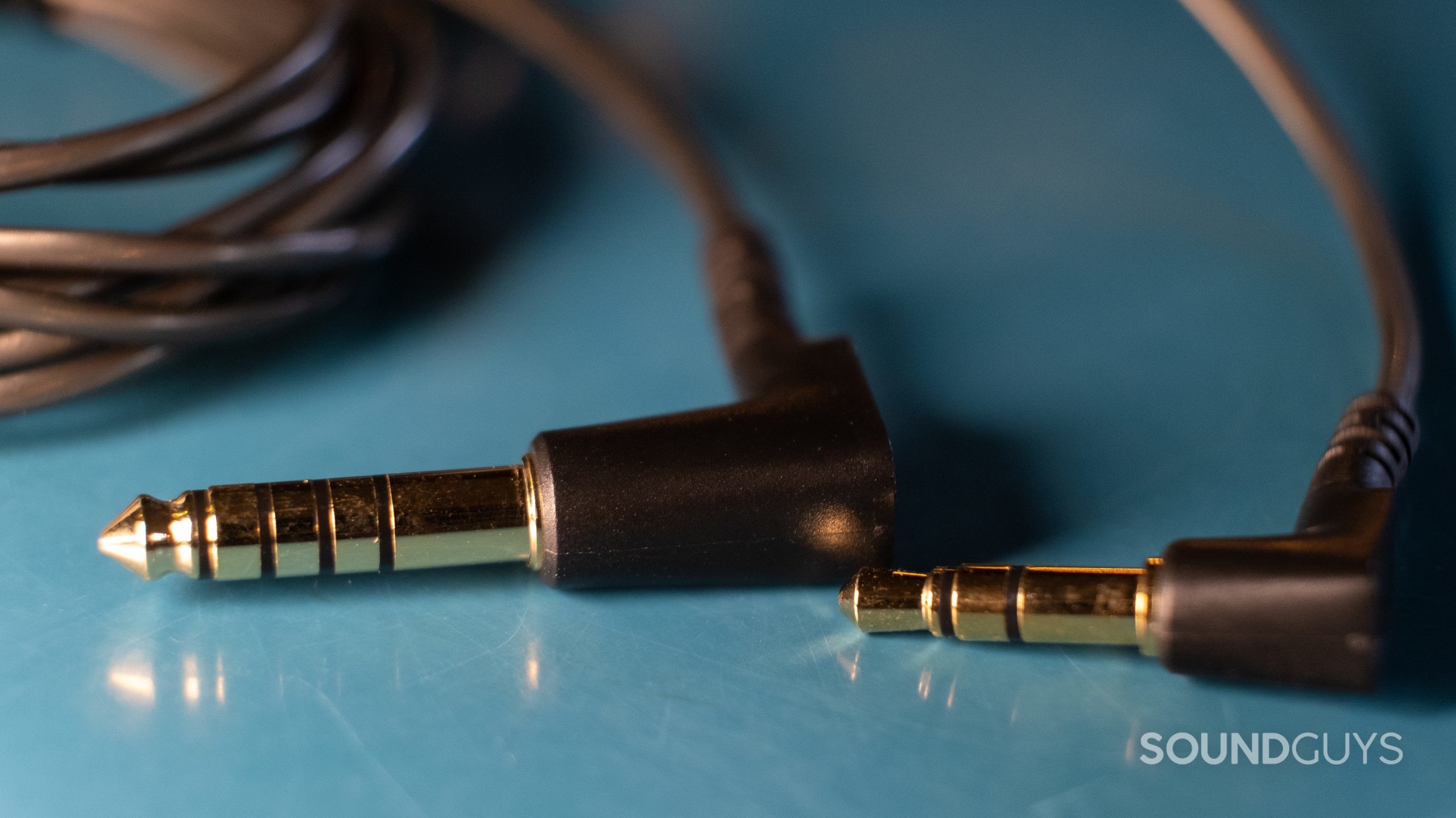 A close up comparing the 4.4mm balanced jack with the 3.5mm unbalanced jack for the Sennheiser IE 600.