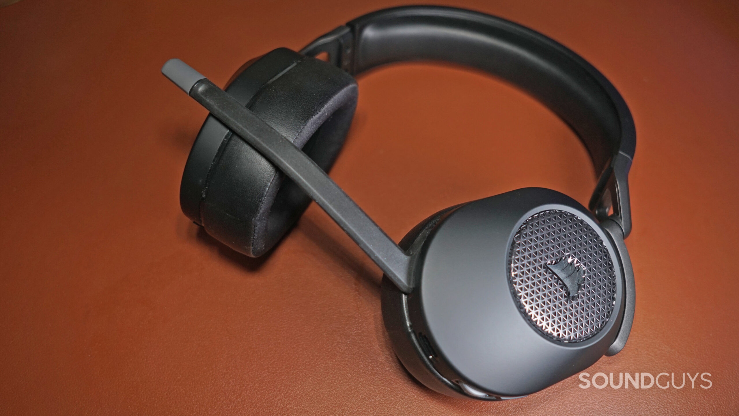 The Corsair HS65 Wireless lays on a leather surface