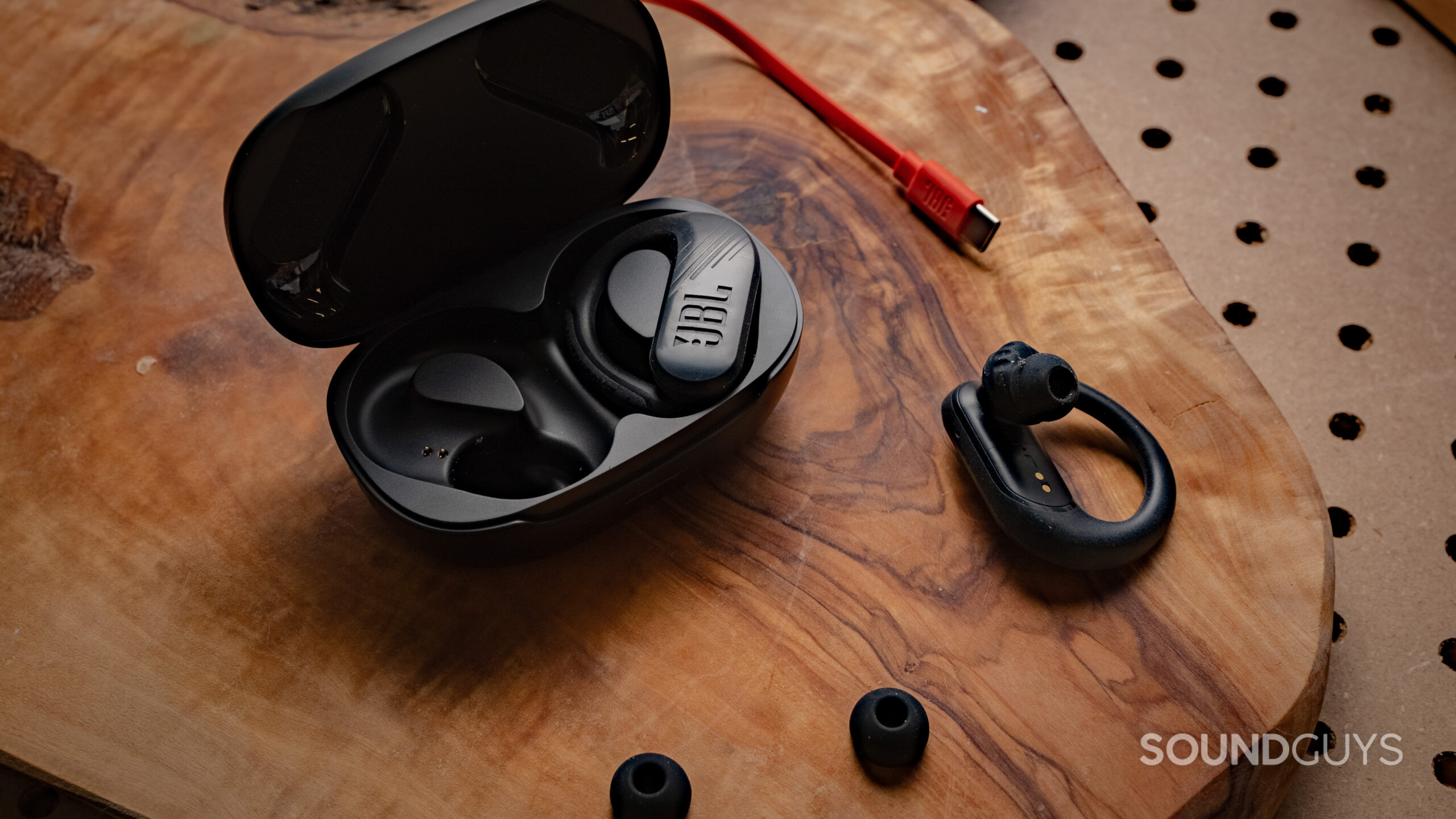 JBL Endurance Peak 3 earbuds, ear tips, and charging cable on table