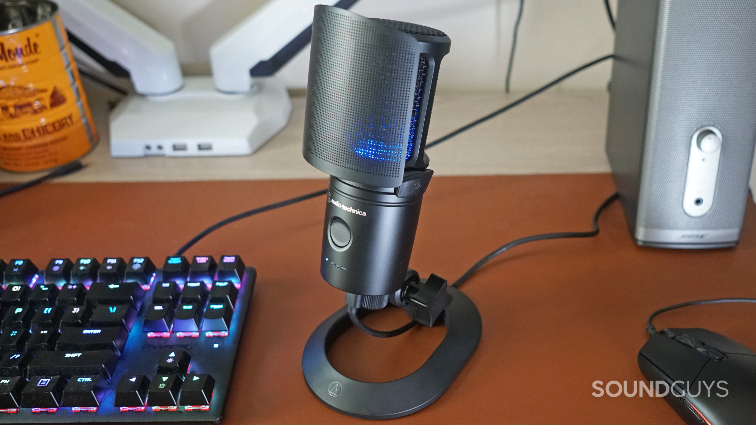 The AT2020USB-XP sitting on a wooden desk next to a keyboard and mouse.