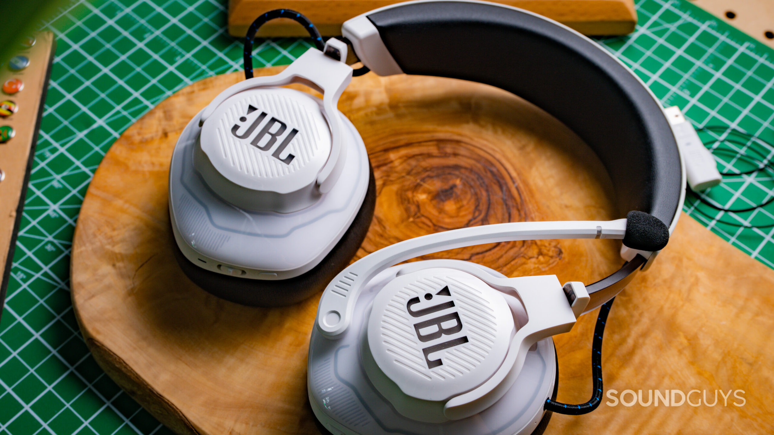 The JBL Quantum 910P sitting on a tabletop with the JBL logos on both ear cups clearly visible.