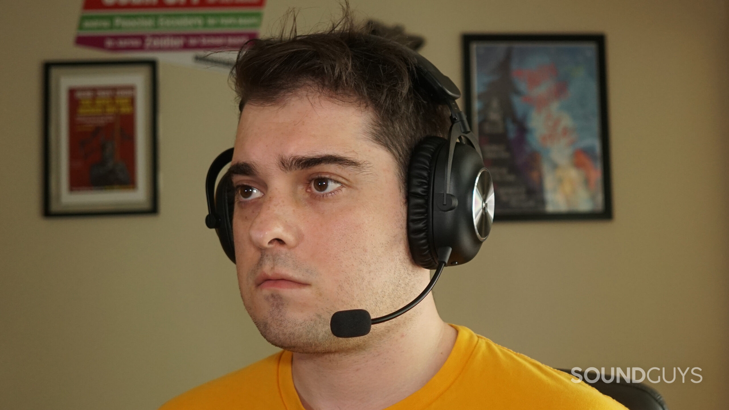 A man wears the Logitech G PRO X 2 LIGHTSPEED gaming headset while sitting at a computer.