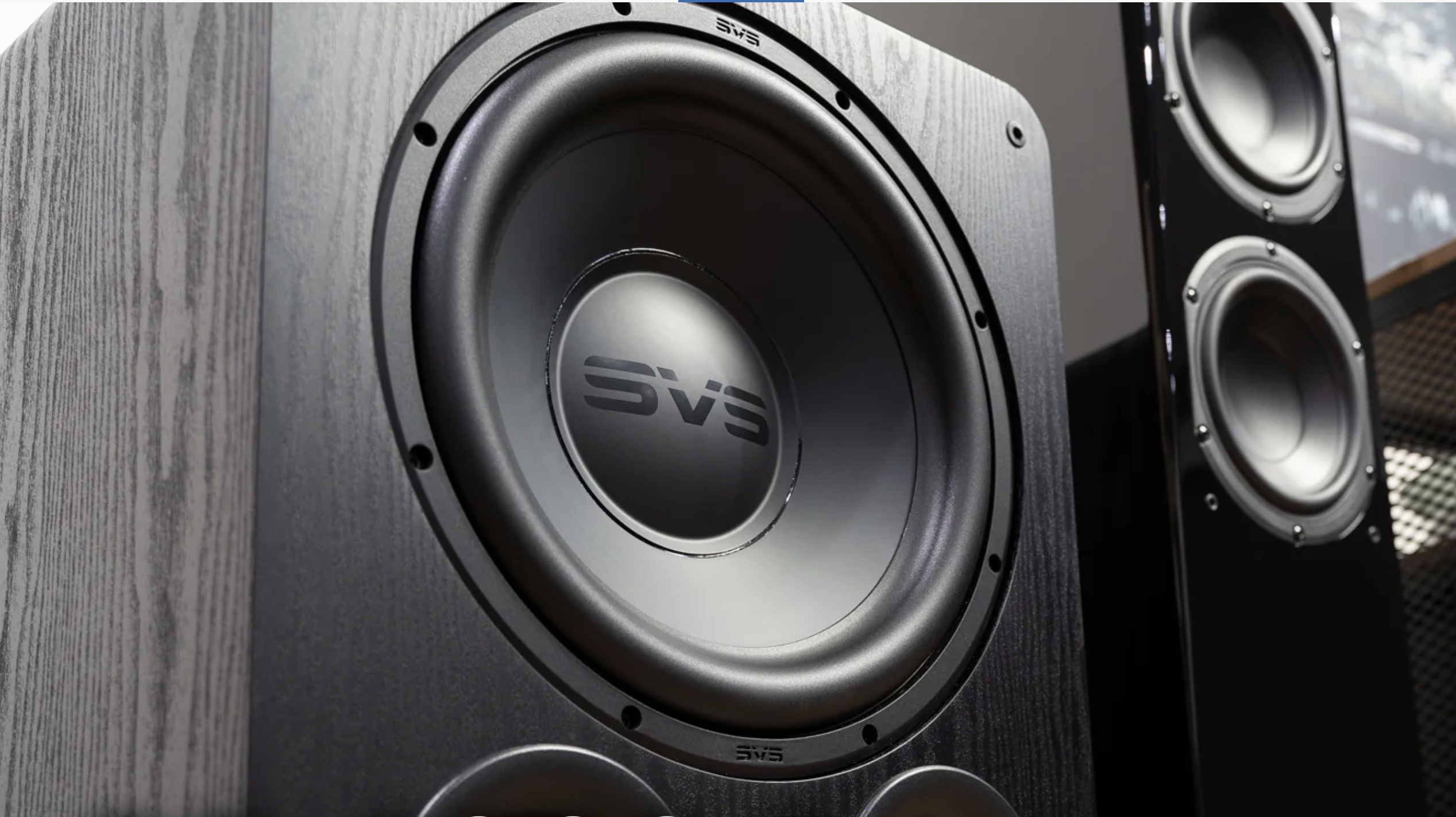 SVS Sub Subwoofer next to a floor-standing full range speaker