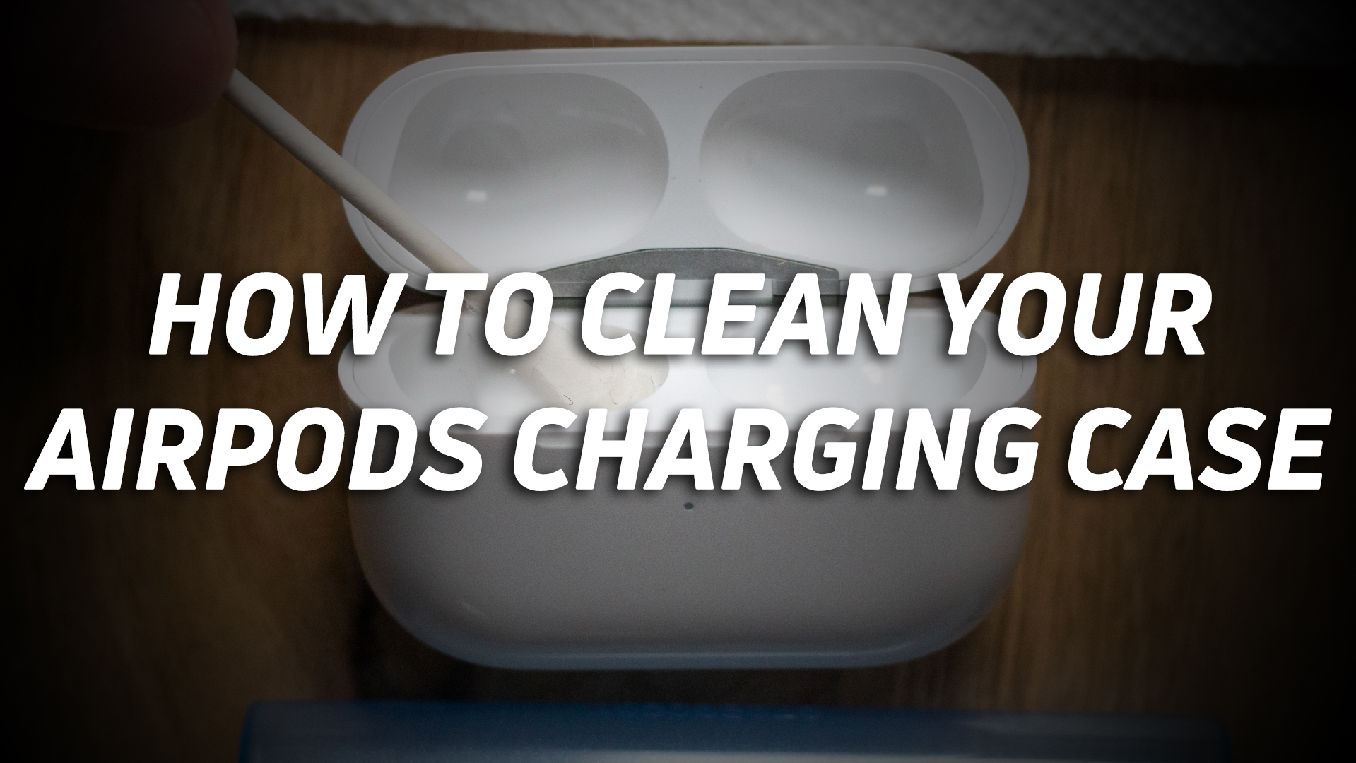 A photo of an Apple AirPods charging case getting cleaned, with the text "how to clean your AirPods charging case" overlaid.