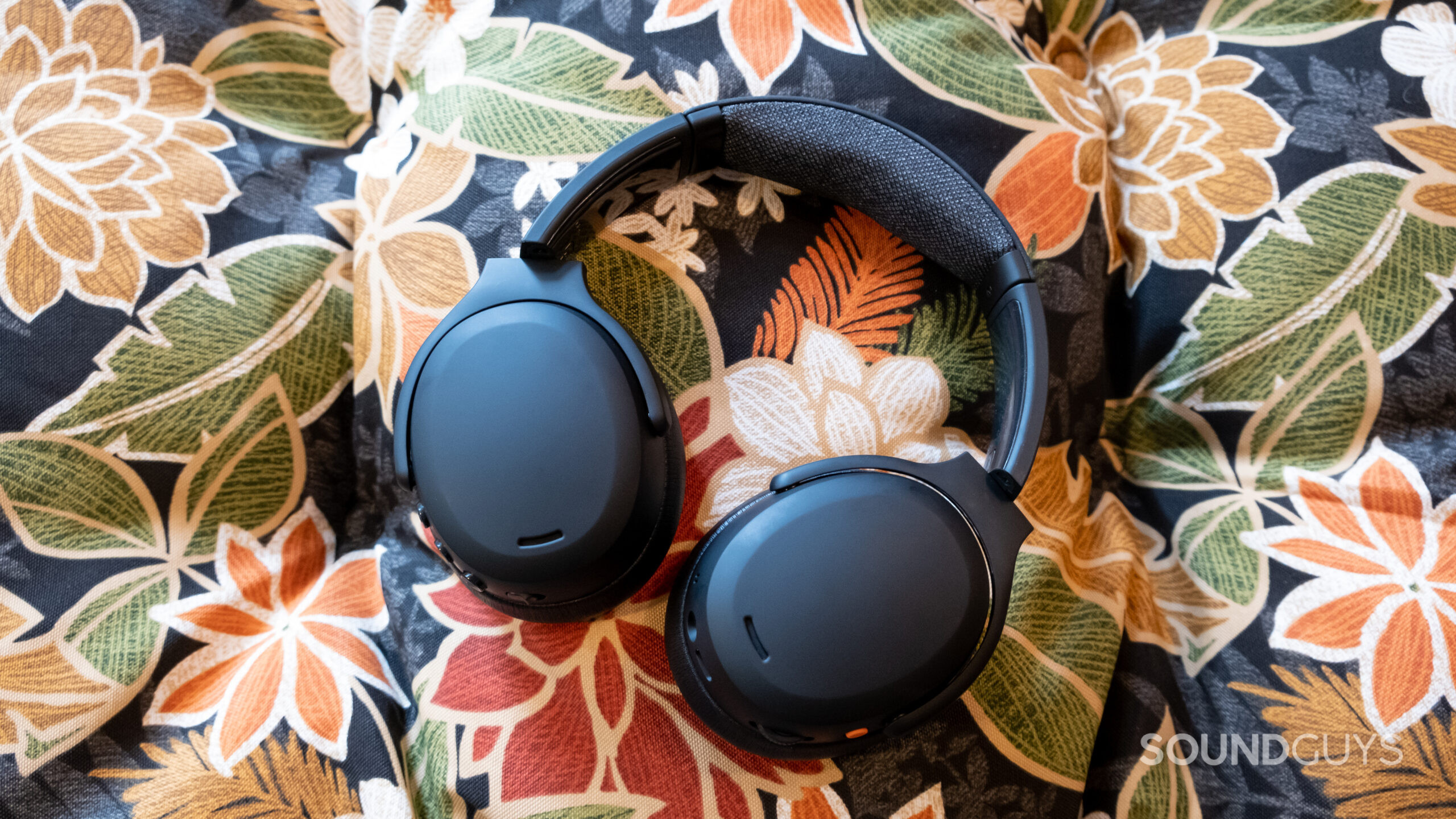 A centered photo of the Skullcandy Crusher ANC 2 against a floral background fabric.
