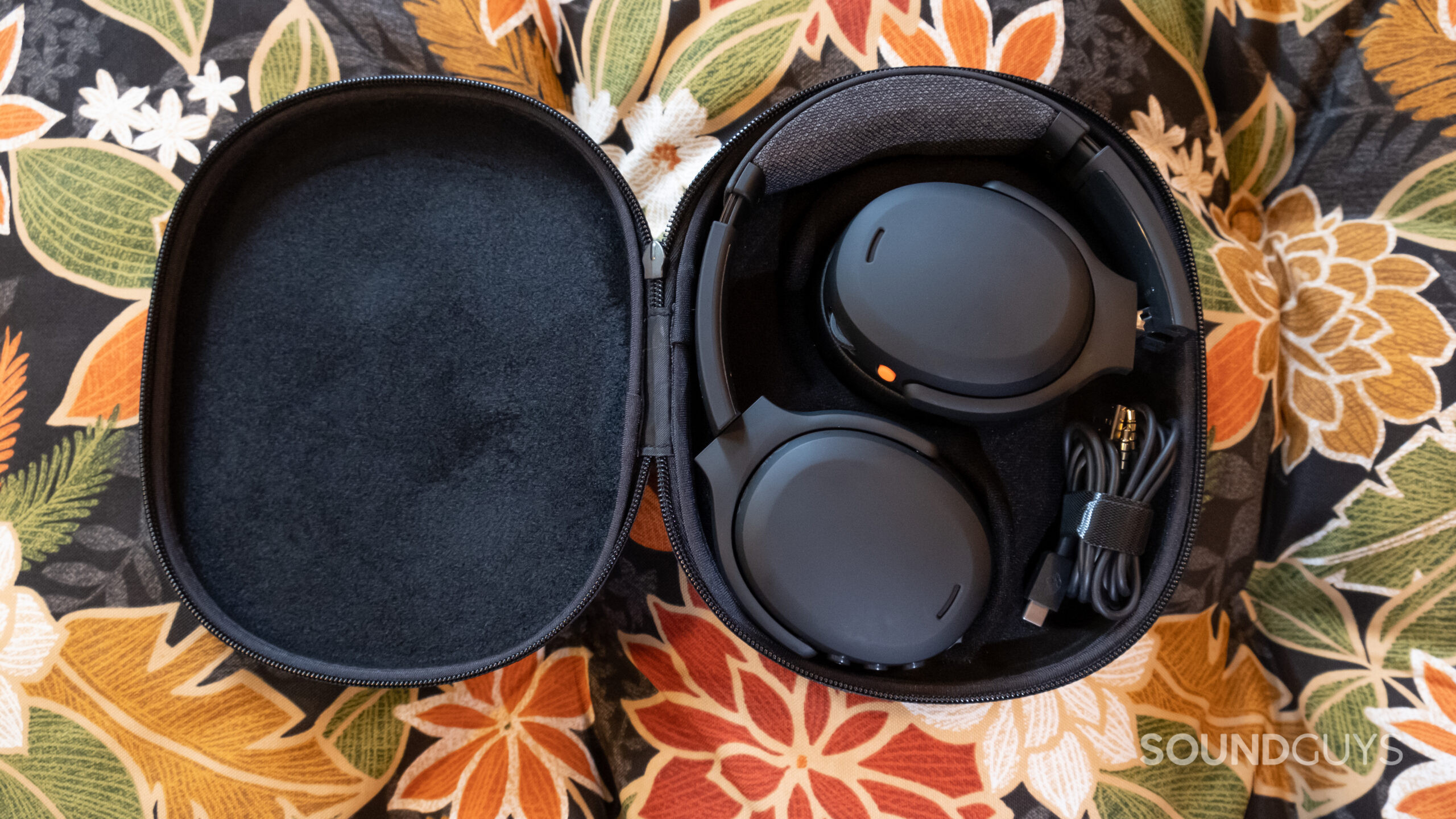 The Skullcandy Crusher ANC 2 folded into its open case with accessories.