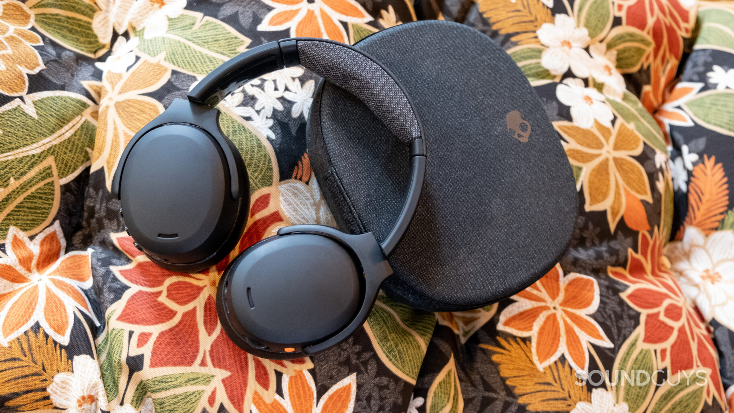 The Skullcandy Crusher ANC 2 rests on its case on a floral background.