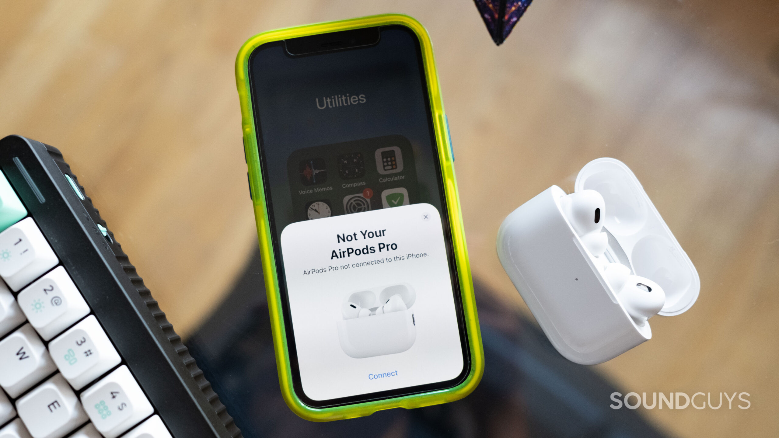 The AirPods Pro 2 and an iPhone 12 mini in pairing mode.