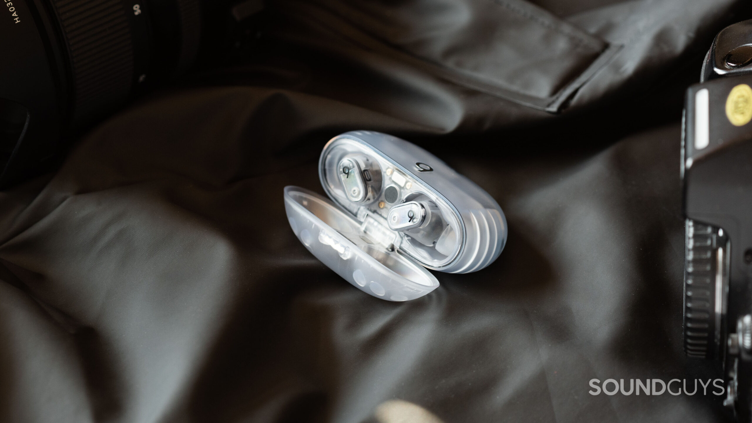 The Beats Studio Buds Plus sit inside the open case which is slightly angled to the left.