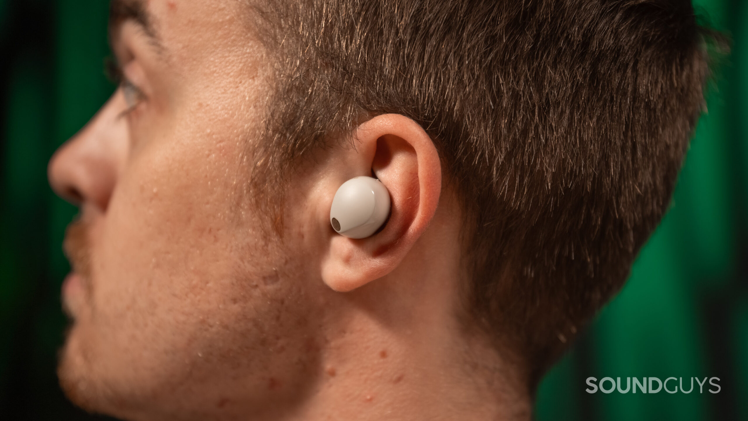 Close up of a man wearing the left earbud of the Sony WF-1000XM5