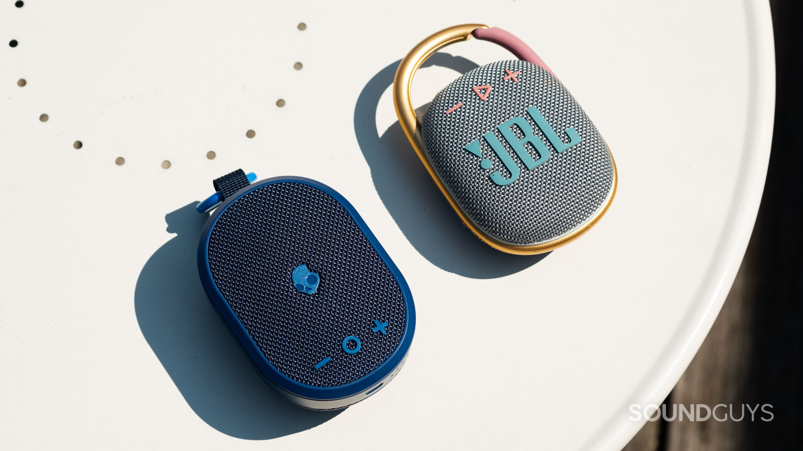The Skullcandy Kilo and JBL Clip 4 Bluetooth speakers next to each other.