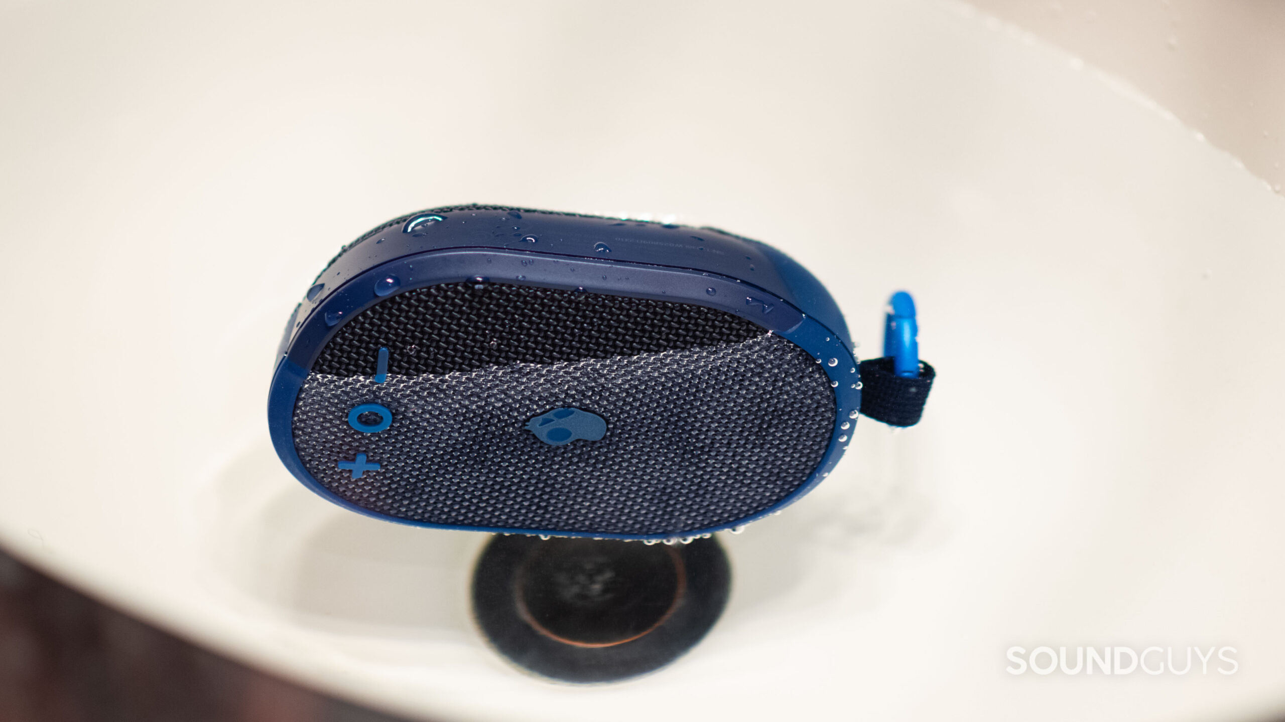 The Skullcandy Kilo floating in a sink.