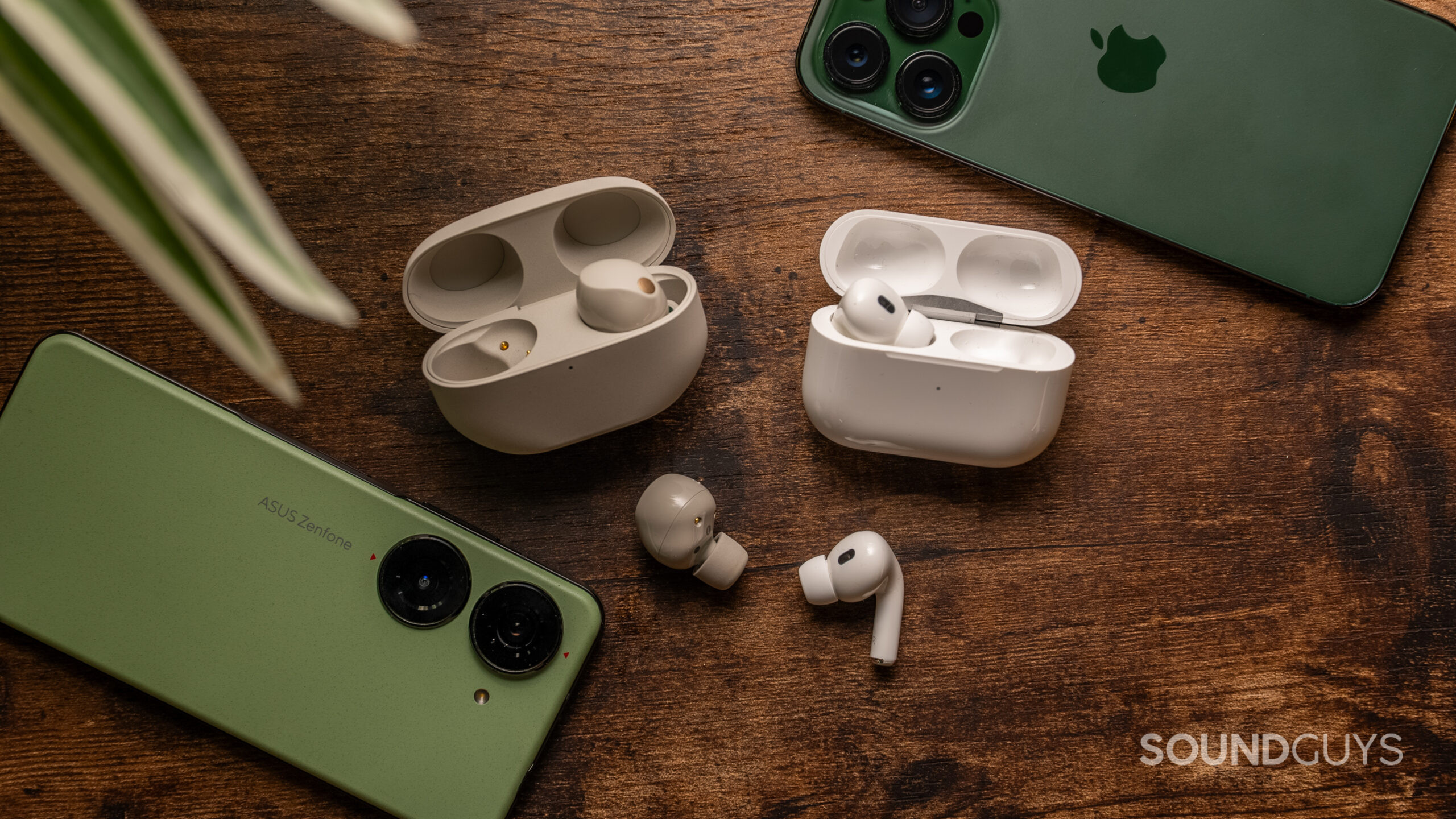 The Sony WF-1000XM5 and Apple AirPods Pro 2 next to each other with one bud out of the case for each.