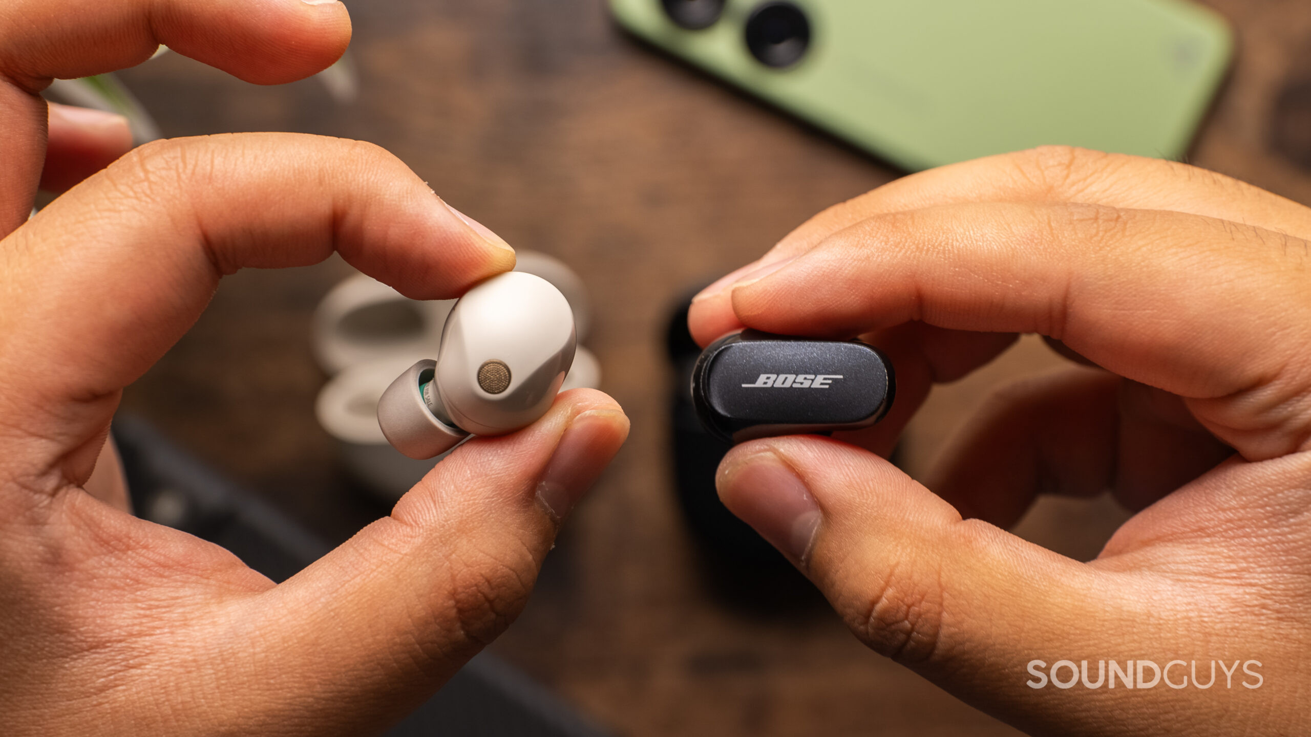 A closeup of the Sony WF-1000XM5 and the Bose QuietComfort Earbuds II side by side.