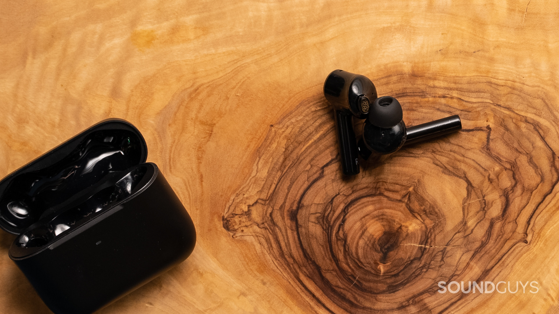 A photo of the Razer Hammerhead Pro Hyperspeed lying atop wood.