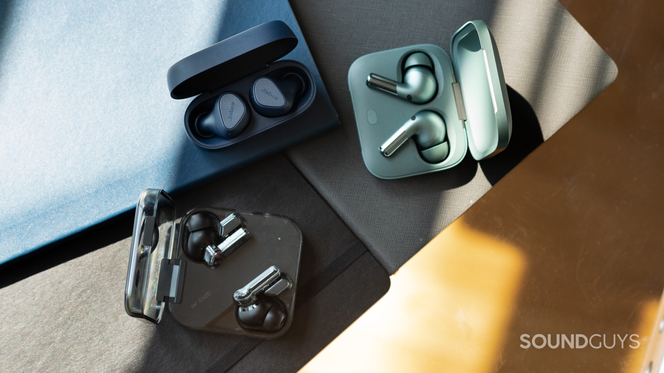 Jabra Elite 4 OnePlus Buds Pro 2 Nothing Ear 1-1 The Jabra Elite 4, OnePlus Buds Pro 2, and Nothing Ear 1 earbuds in their open cases.