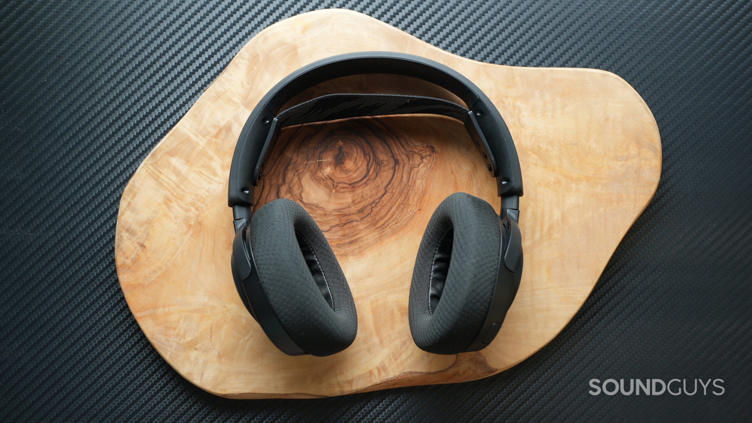 The SteelSeries Arctis Nova 4 sitting on a wooden table backdrop.