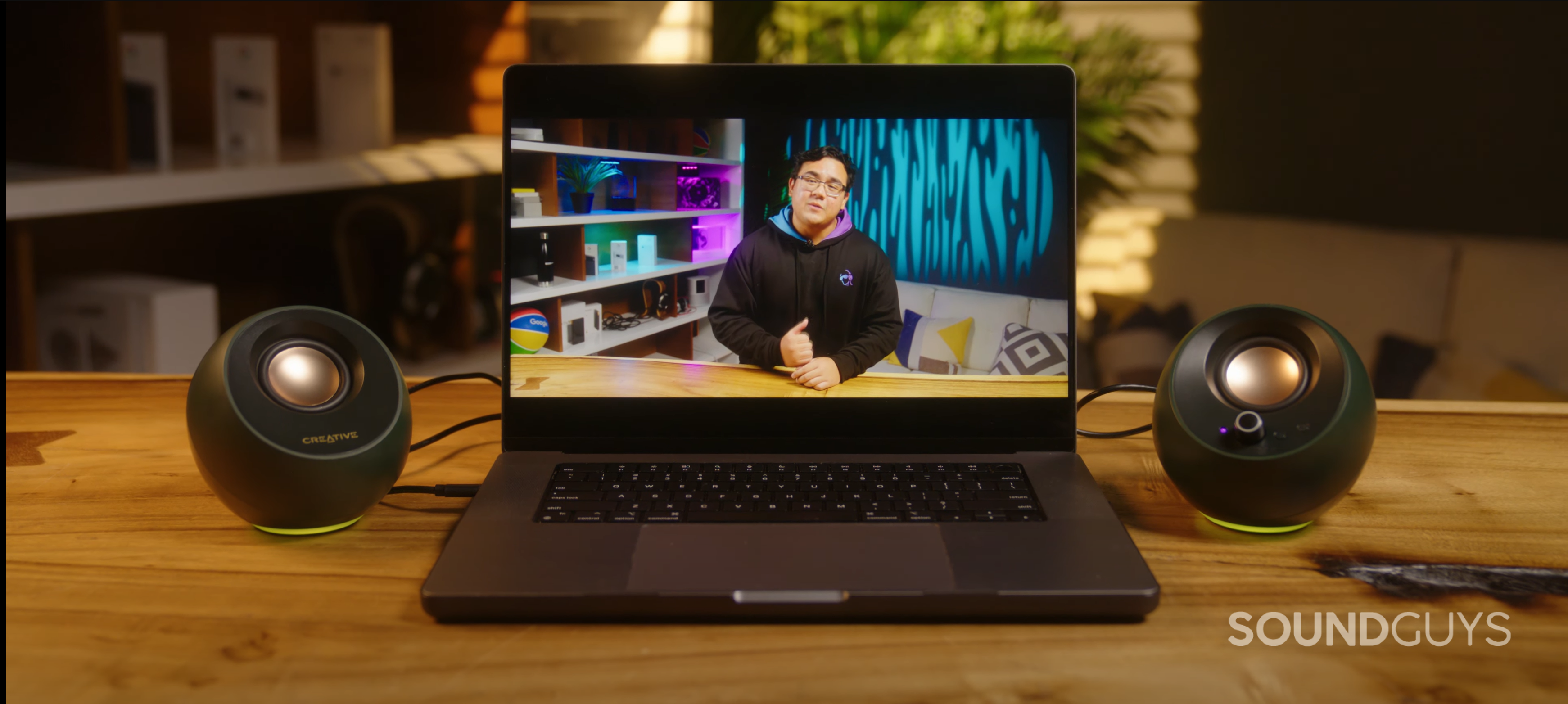 the creative pebble pro speakers beside a laptop computer playing a youtube video