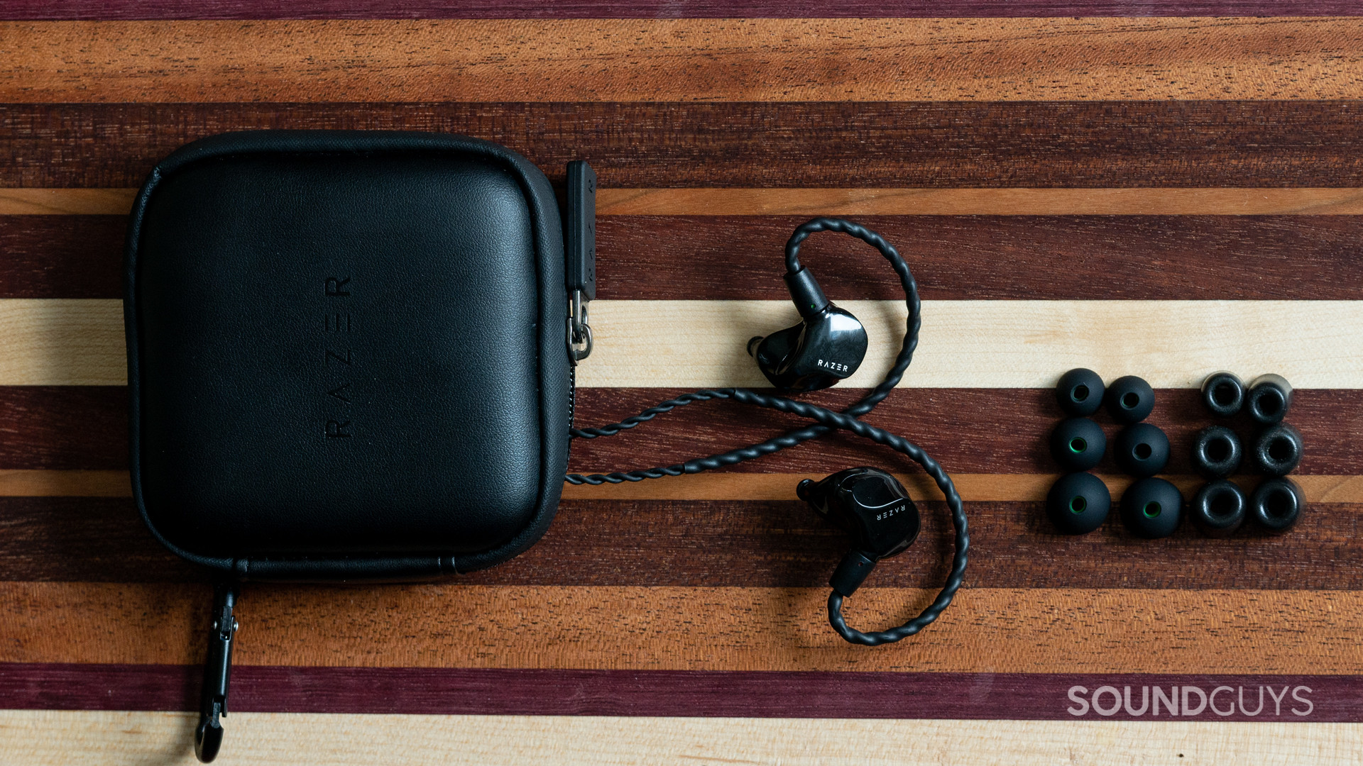 The contents of the Razer Moray's product packaging, splayed out on a wooden cutting board.