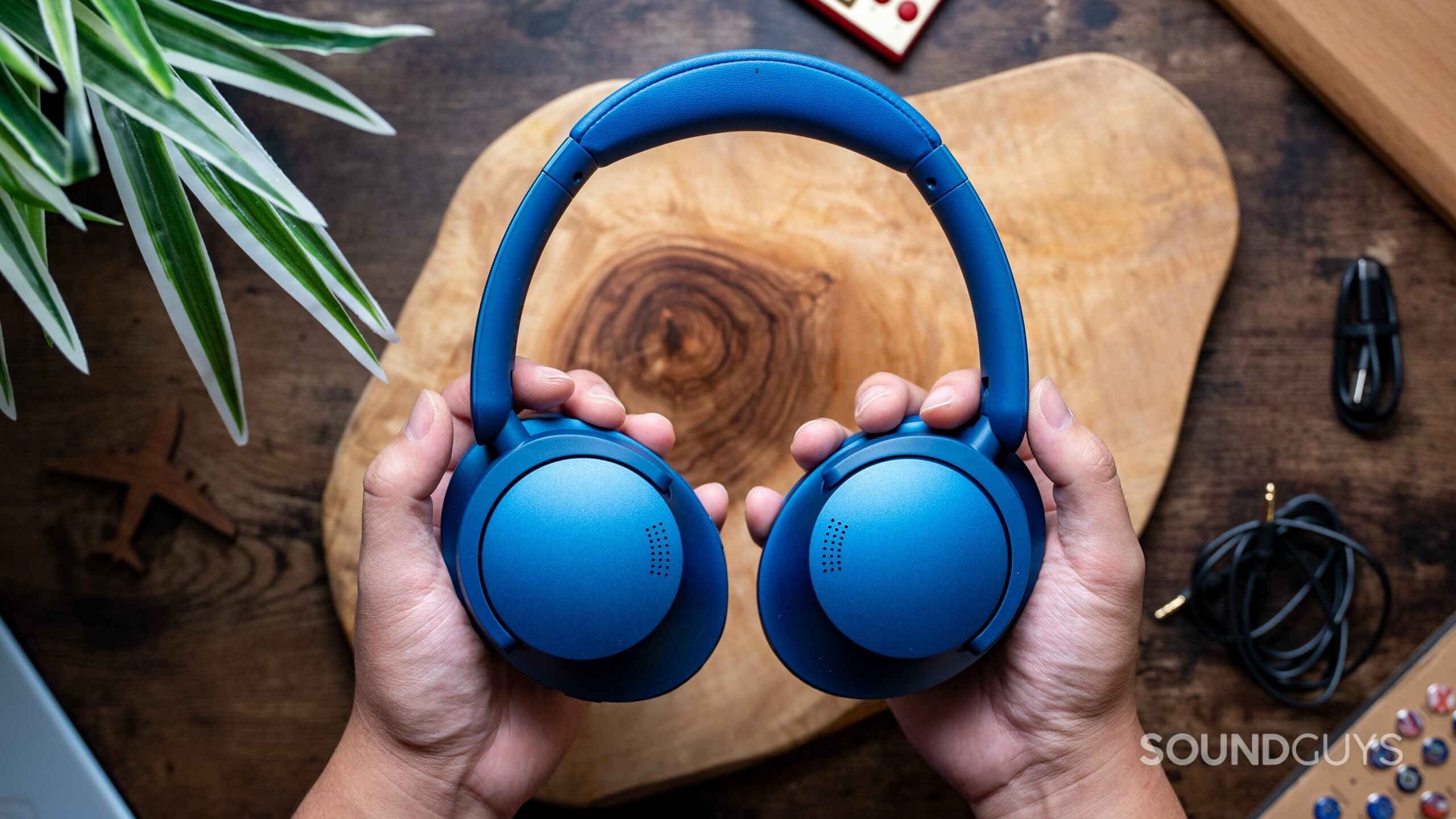 Top view of hands holding the SonoFlow headphones