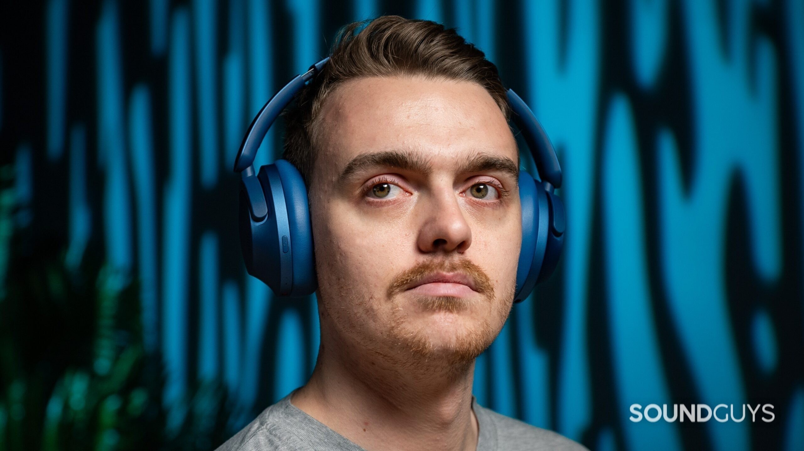 A man wearing the 1MORE SonoFlow headphones