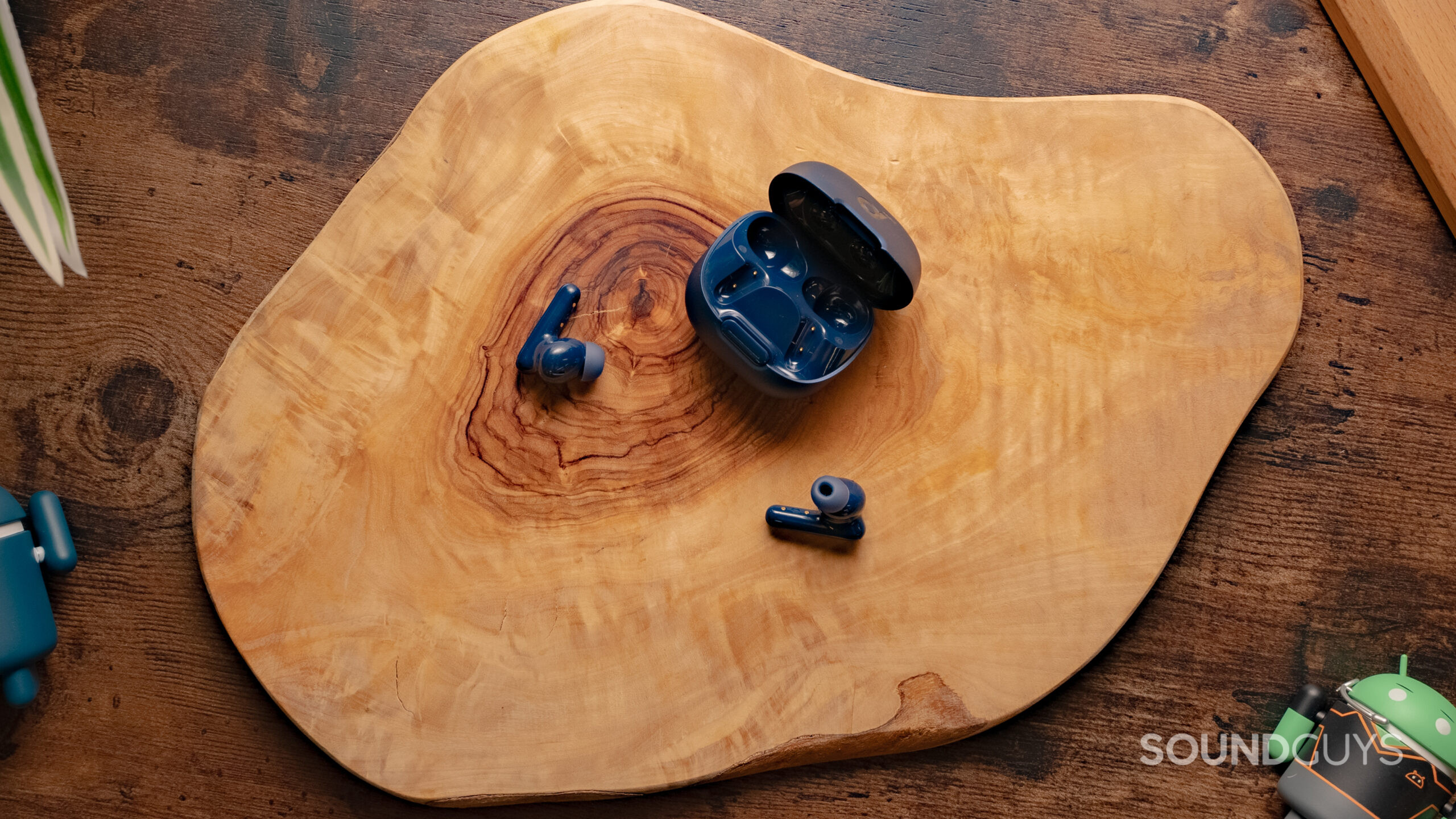 The Anker Soundcore Liberty 4 NC shown with the case open and buds out on a table.