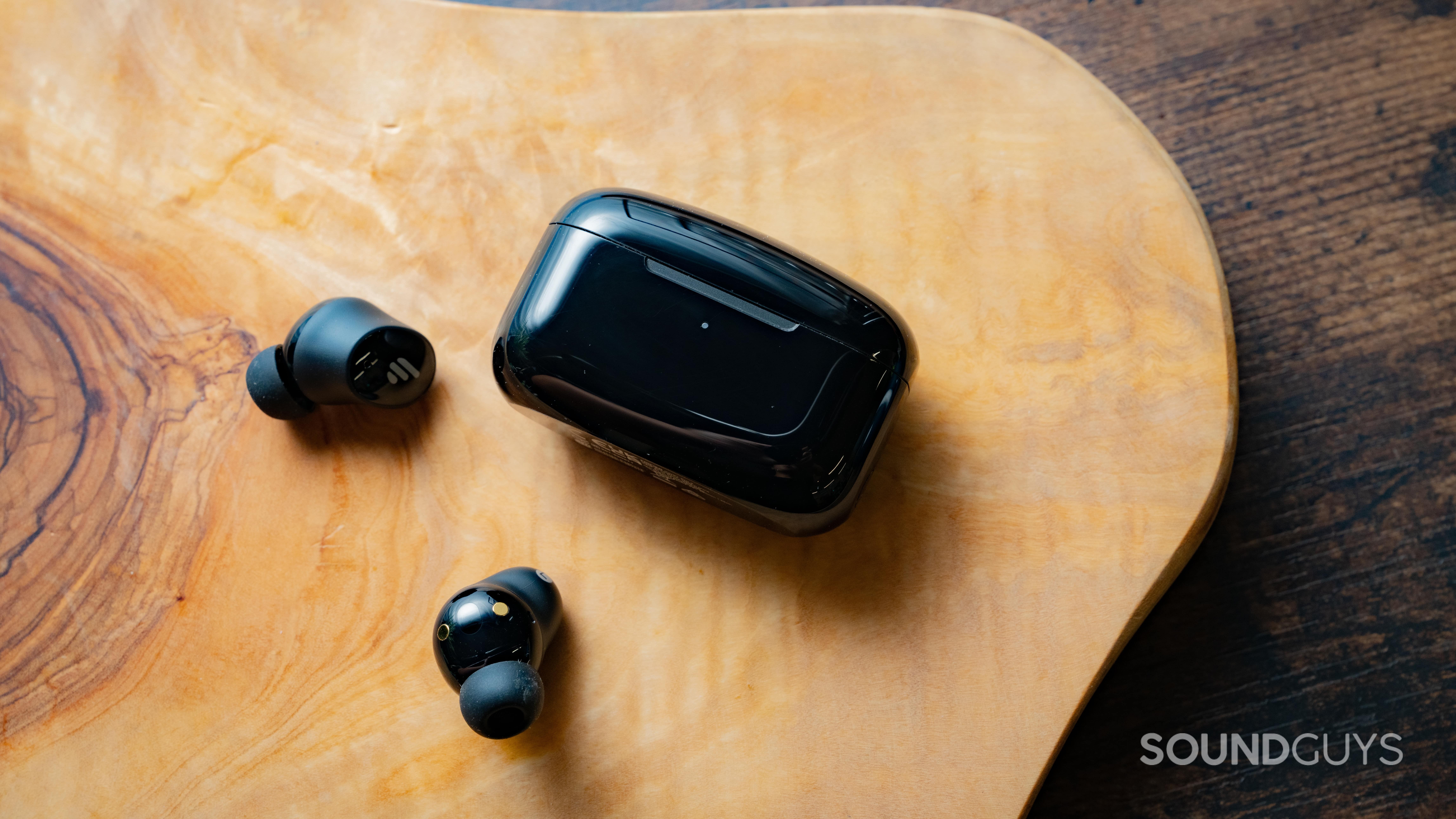 Edifier TWS1 Pro 2 earbuds next to their charging case.
