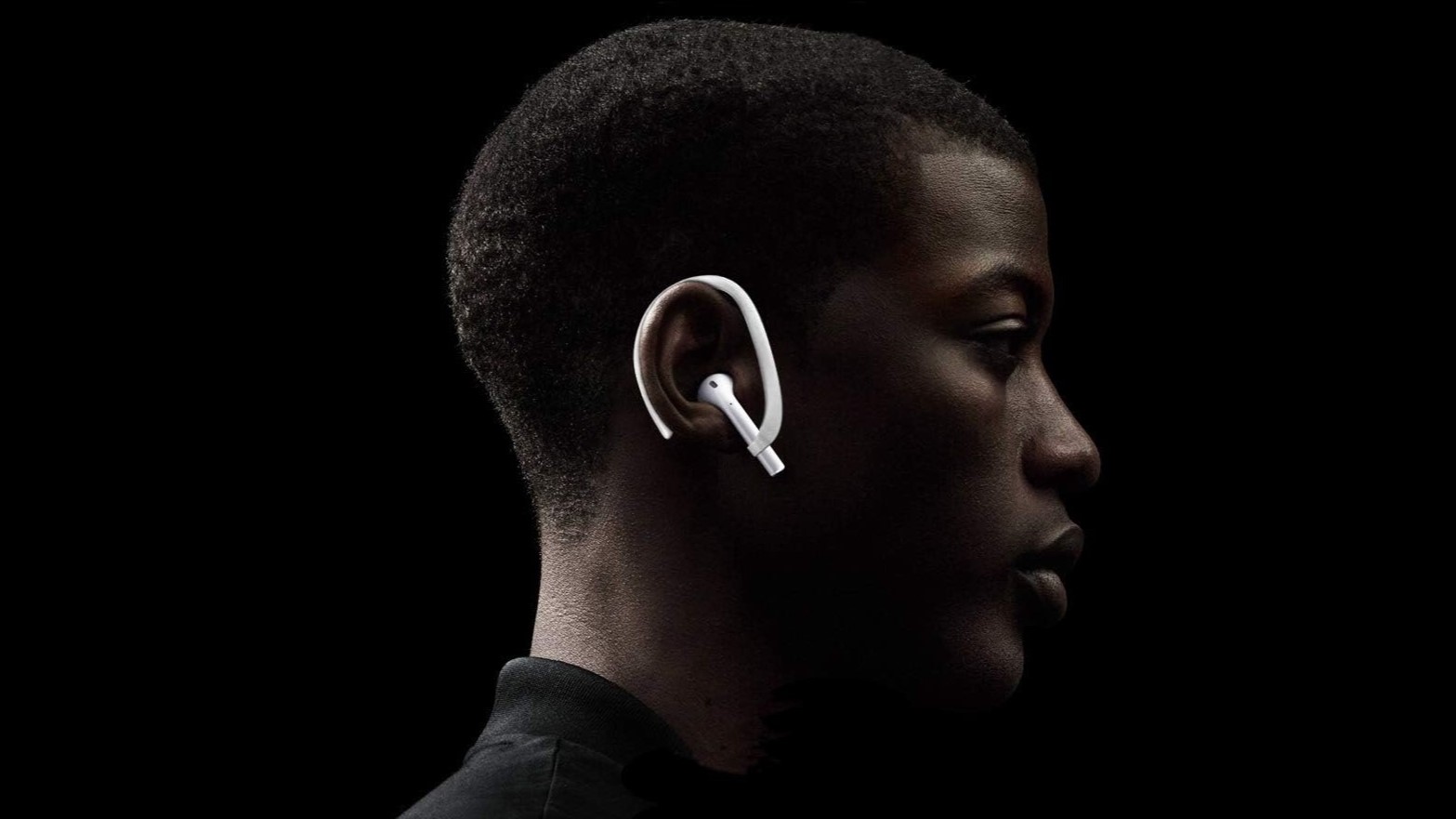 a man wearing white ear hooks for the apple airpods
