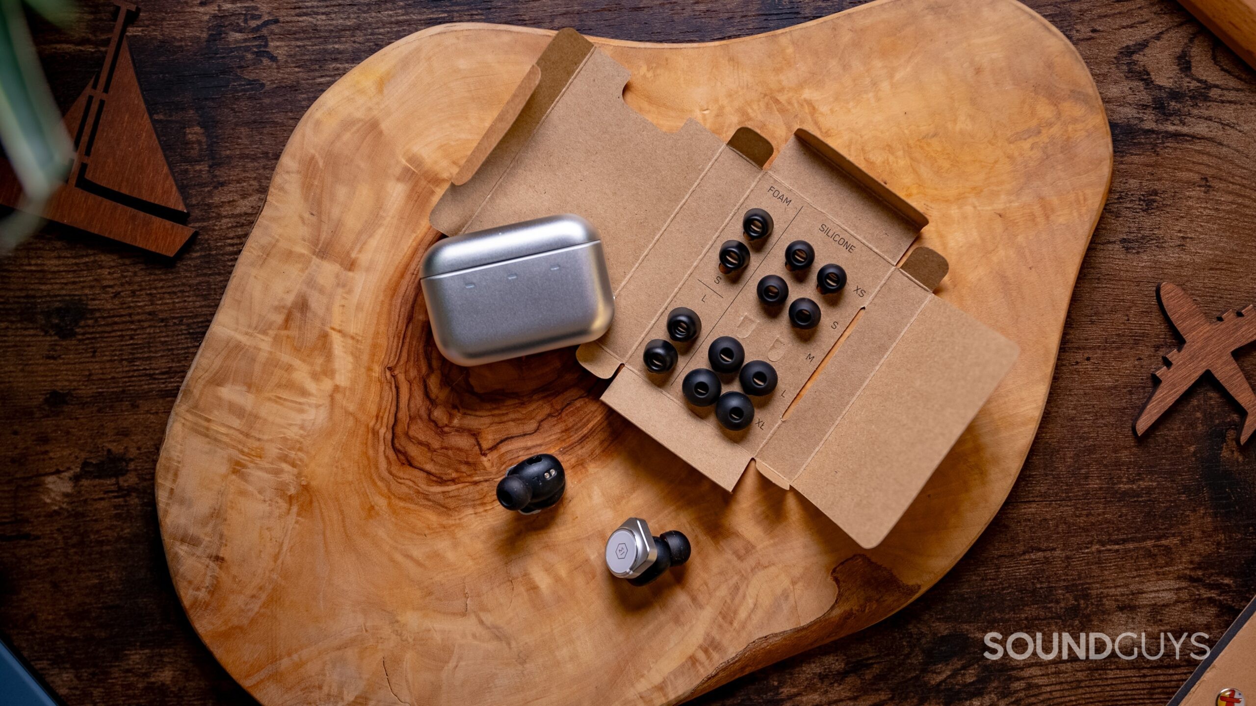 Master &amp; Dynamic MW09 earbuds, ear tips, and charging case. 