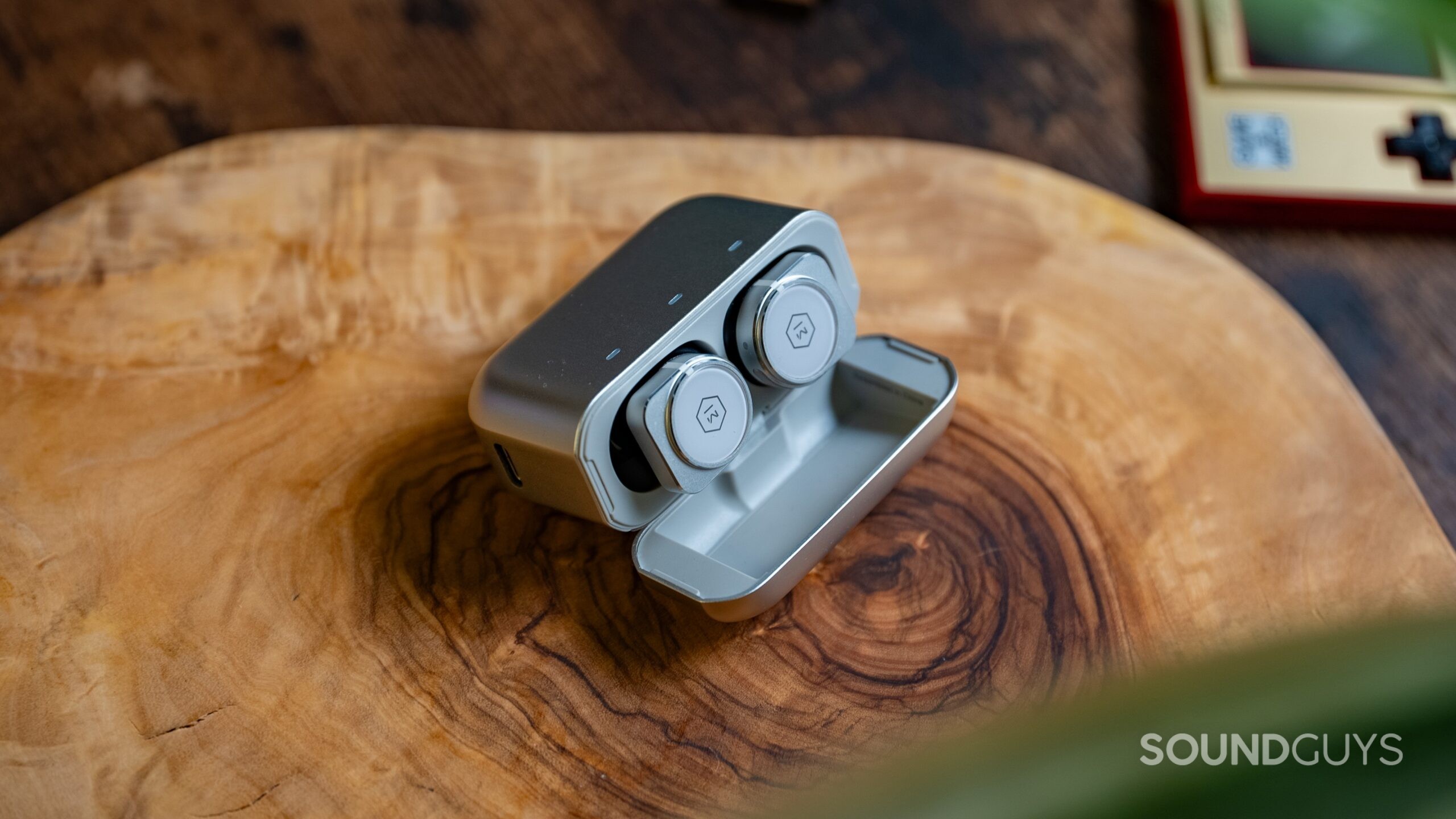 Master &amp; Dynamic MW09 earbuds in their charging case.